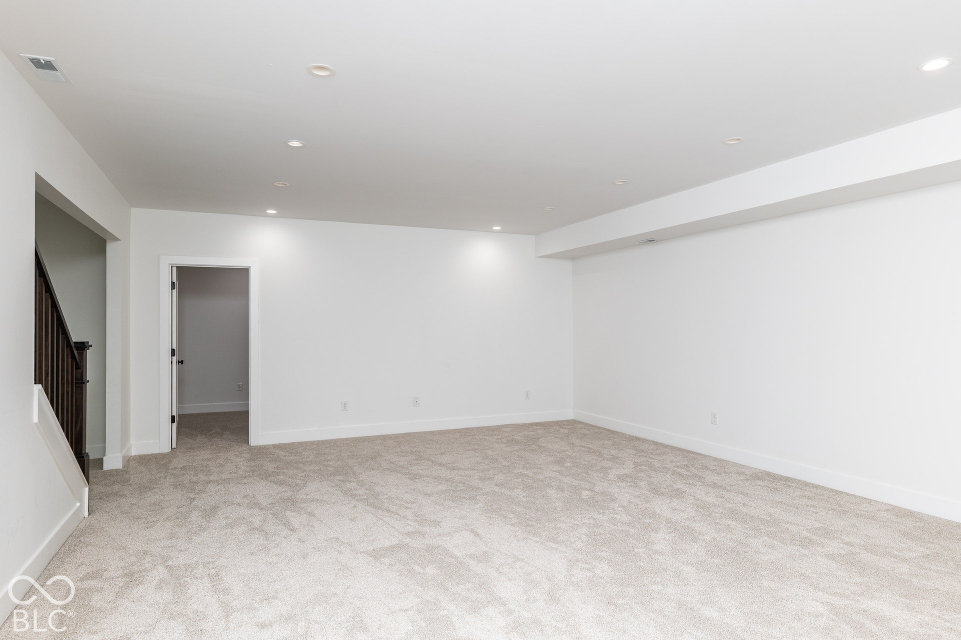 1401 Olive Street, Indianapolis, IN 46203 Neutral-toned carpeting, recessed ceiling lighting, and solid-core interior doors featuring dark wood-finish balusters