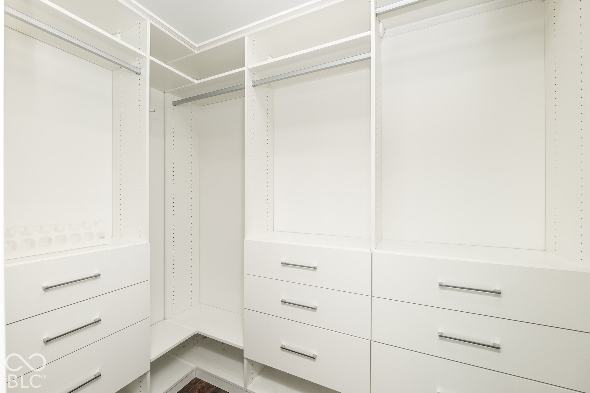 1401 Olive Street, Indianapolis, IN 46203 Custom built-in closet organization system featuring white cabinetry, multiple storage drawers with horizontal pulls, adjustable shelving, and integrated hanging rods