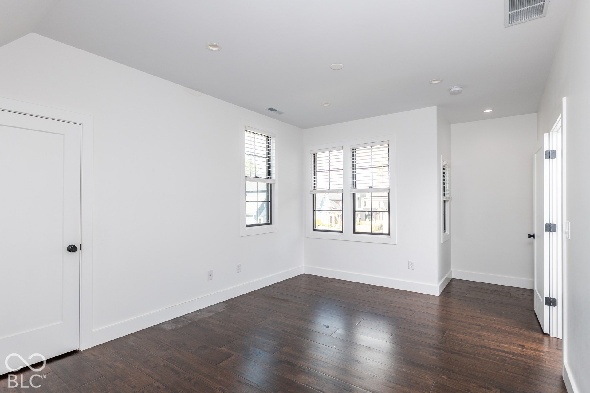 1401 Olive Street, Indianapolis, IN 46203 Neutral interior room featuring wood-finish flooring, recessed lighting, multi-pane windows, and shaker-style doors