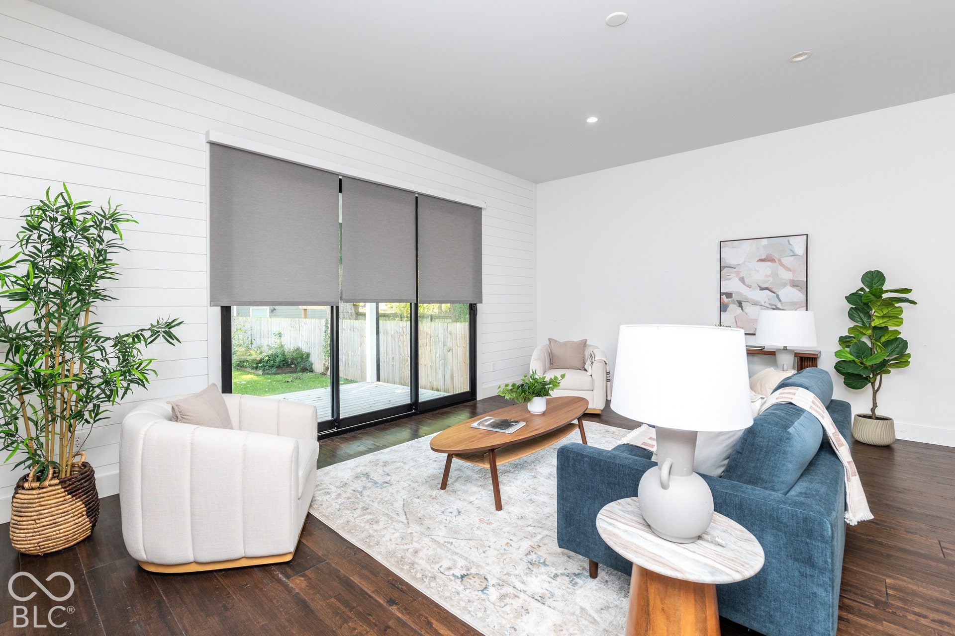 1401 Olive Street, Indianapolis, IN 46203 Living area featuring horizontal shiplap wall paneling, dark wood-finish flooring, recessed lighting, and large sliding glass doors