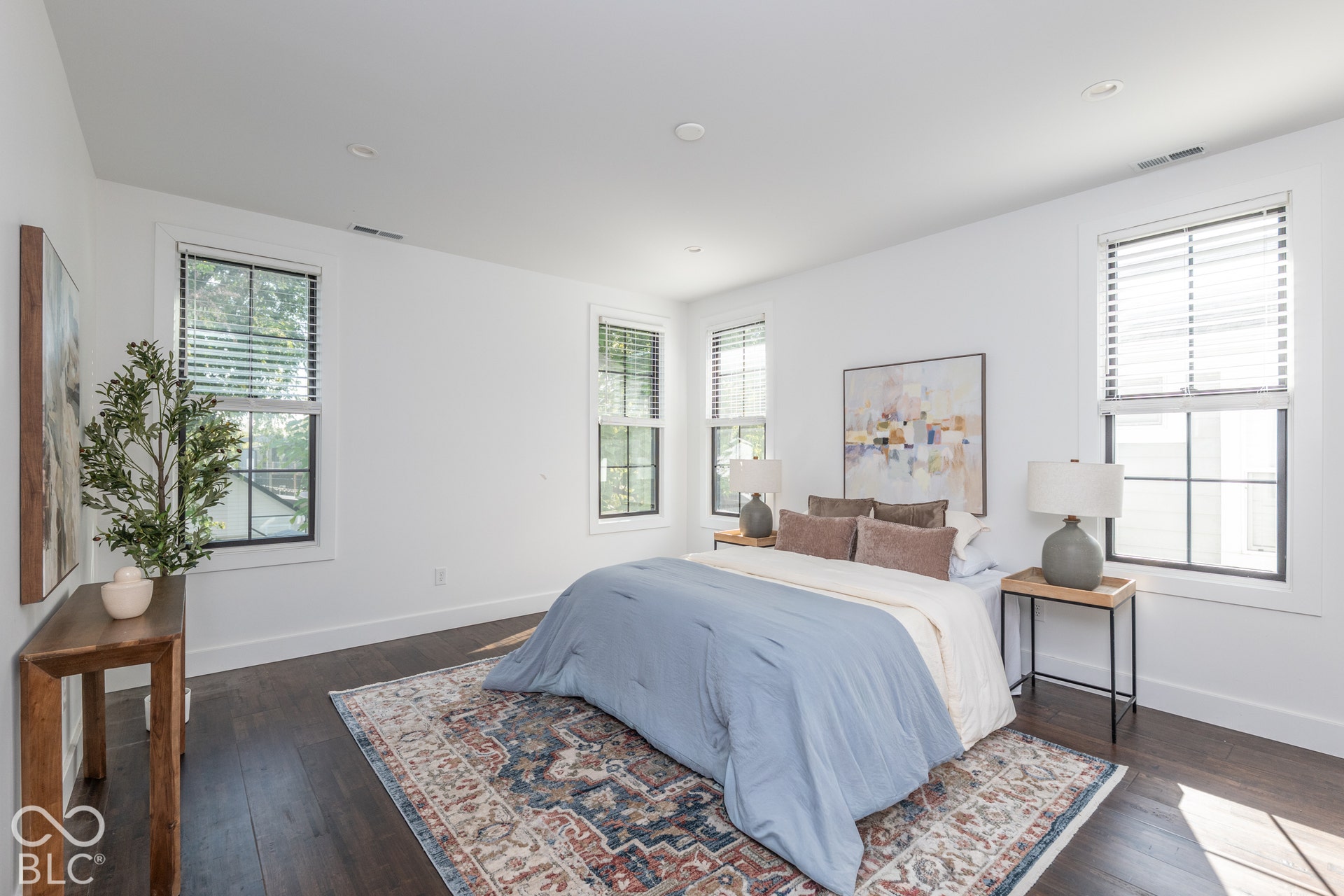 1401 Olive Street, Indianapolis, IN 46203 Dark-toned wood-finish flooring, recessed lighting, and multiple windows with black trim