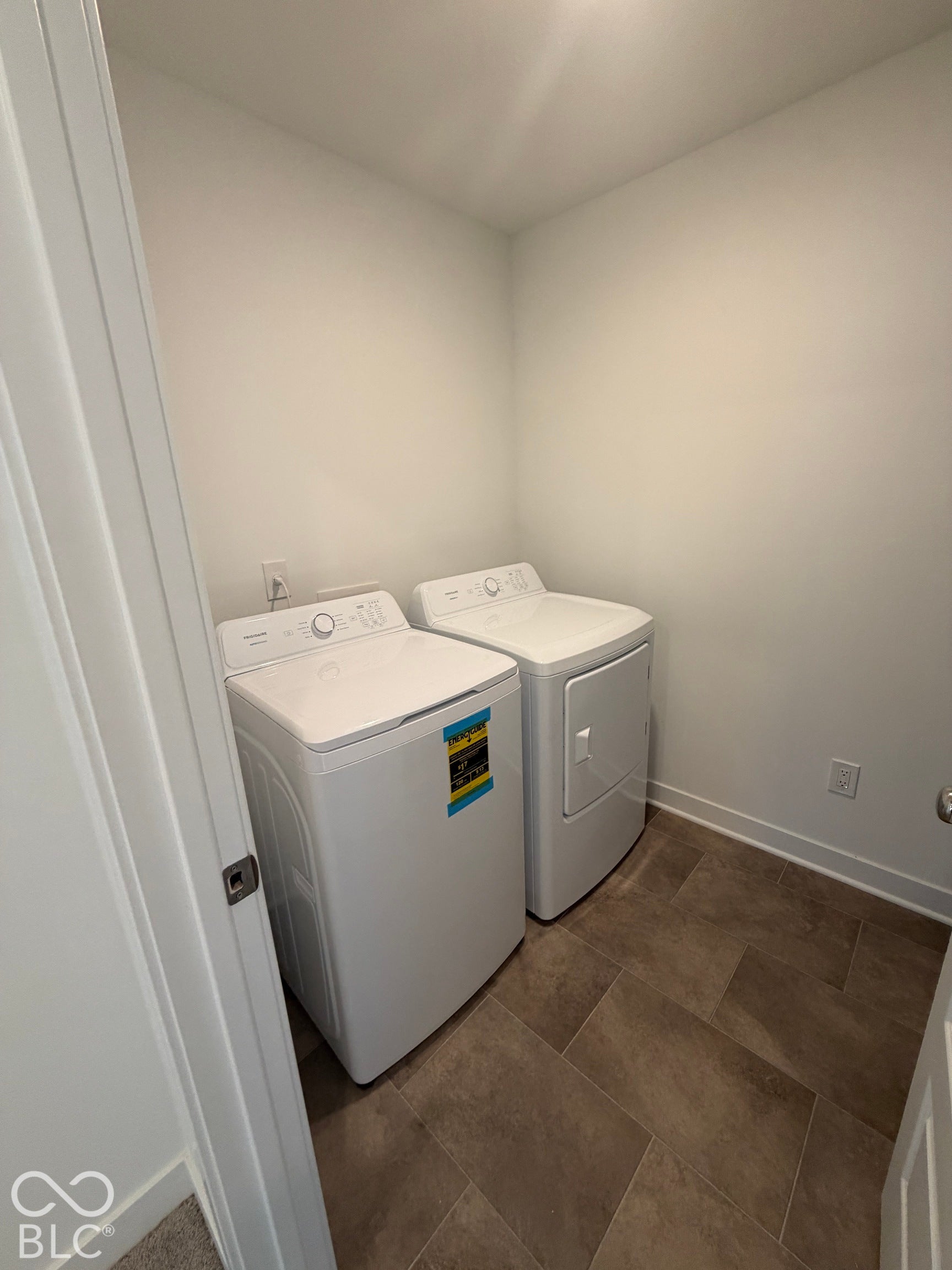 Utility space featuring tile flooring and neutral-toned wall paint