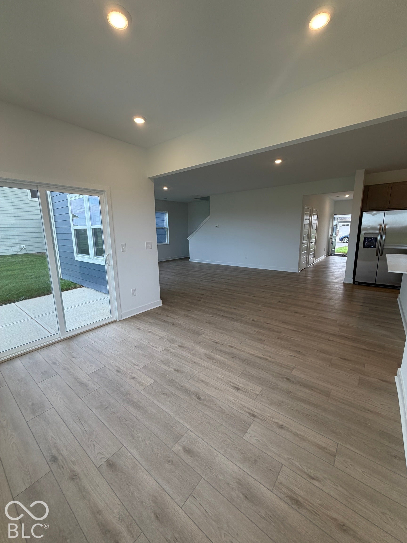 Interior space featuring wood-finish flooring, recessed lighting, and large sliding glass doors providing outdoor access