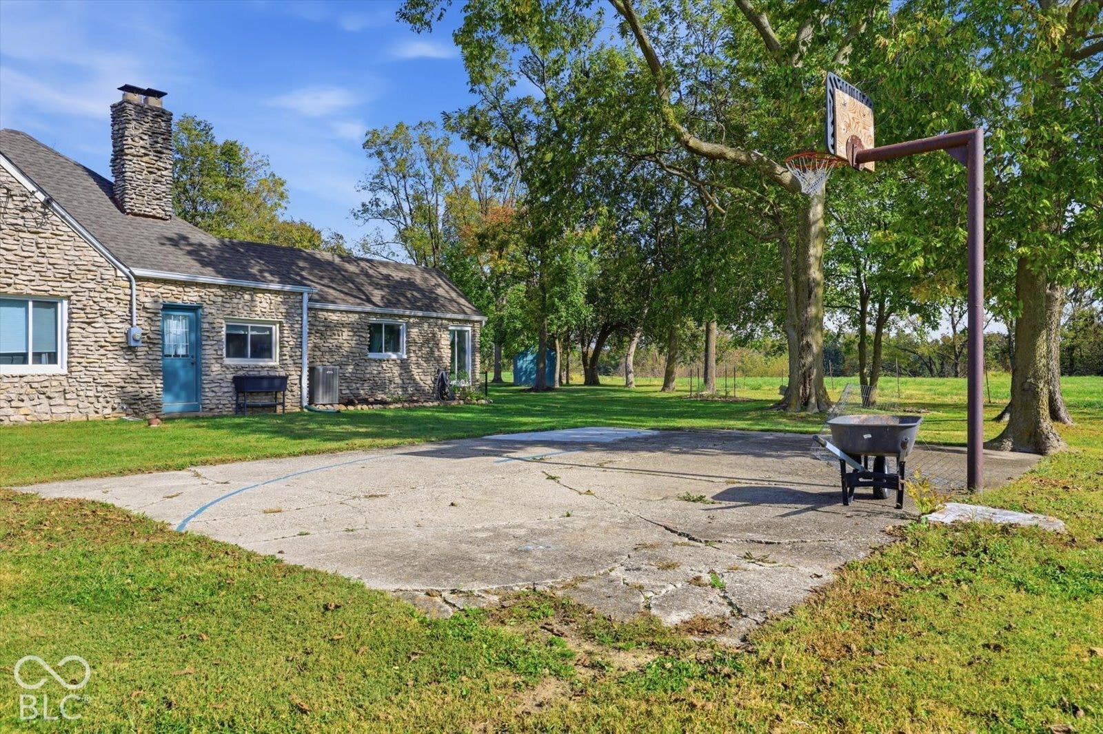 Exterior featuring a natural stone, mature trees on a sprawling lot