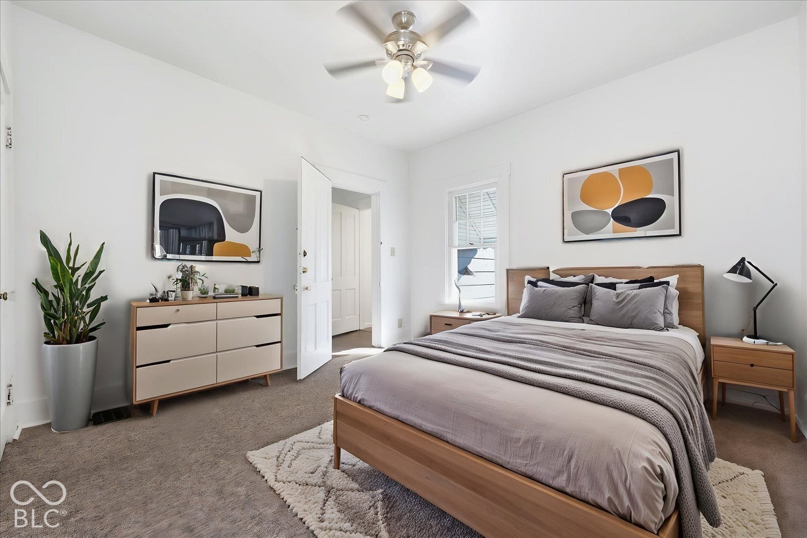 Virtually Altered - Neutral-toned carpeting, ceiling-mounted light fixture with a multi-blade fan, and a single-hung window with white casing