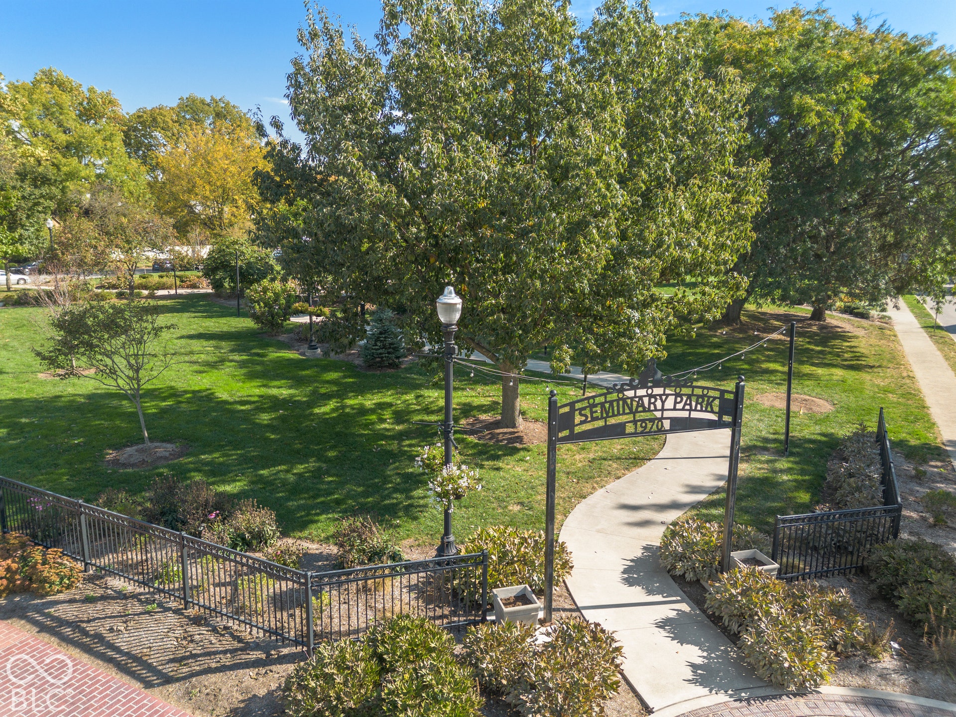 Seminary Park featuring mature trees, manicured lawns, sidewalks, and a park/playground.