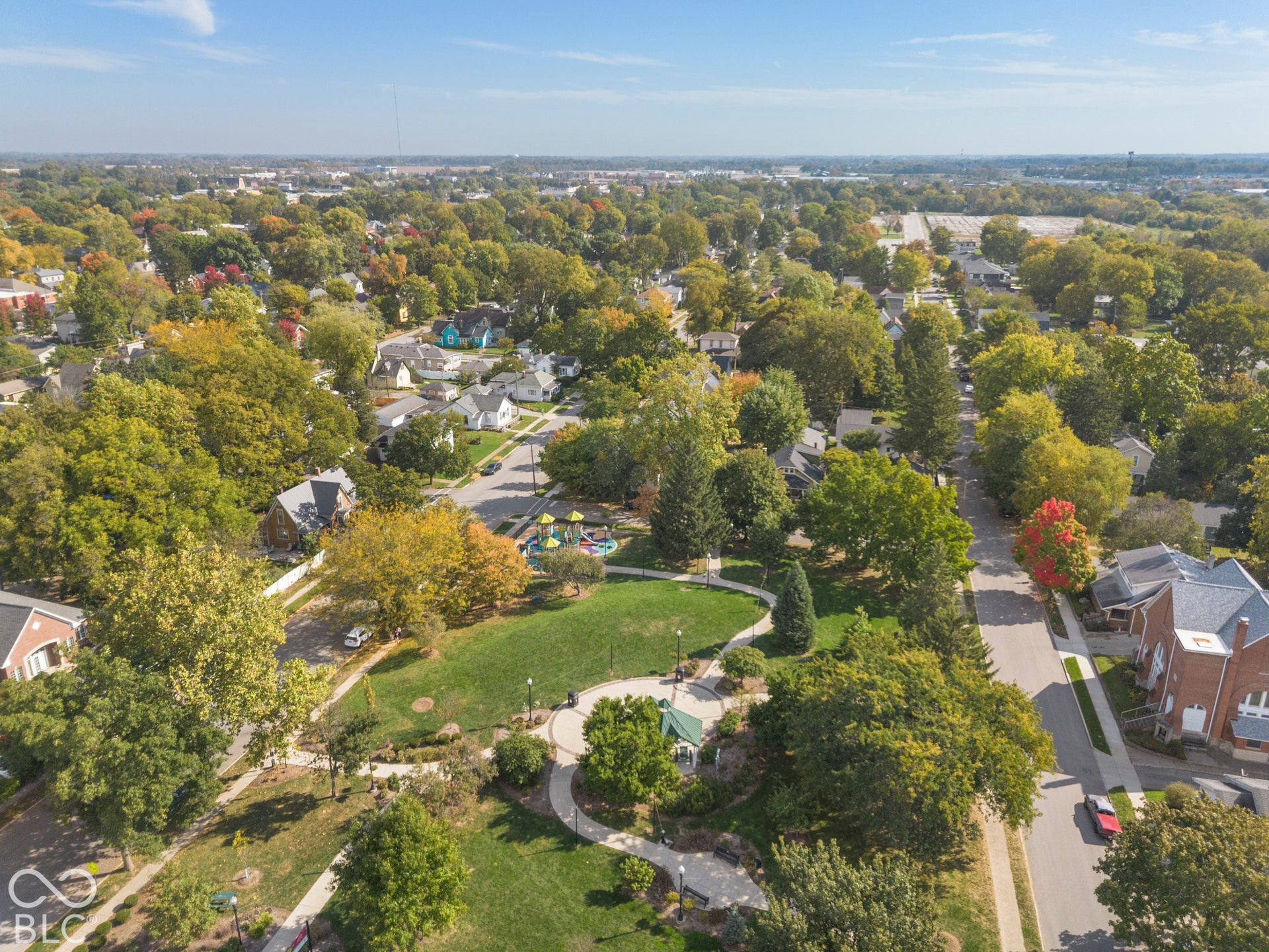 Aerial perspective of a community featuring green space, sidewalks, and lots of trees!