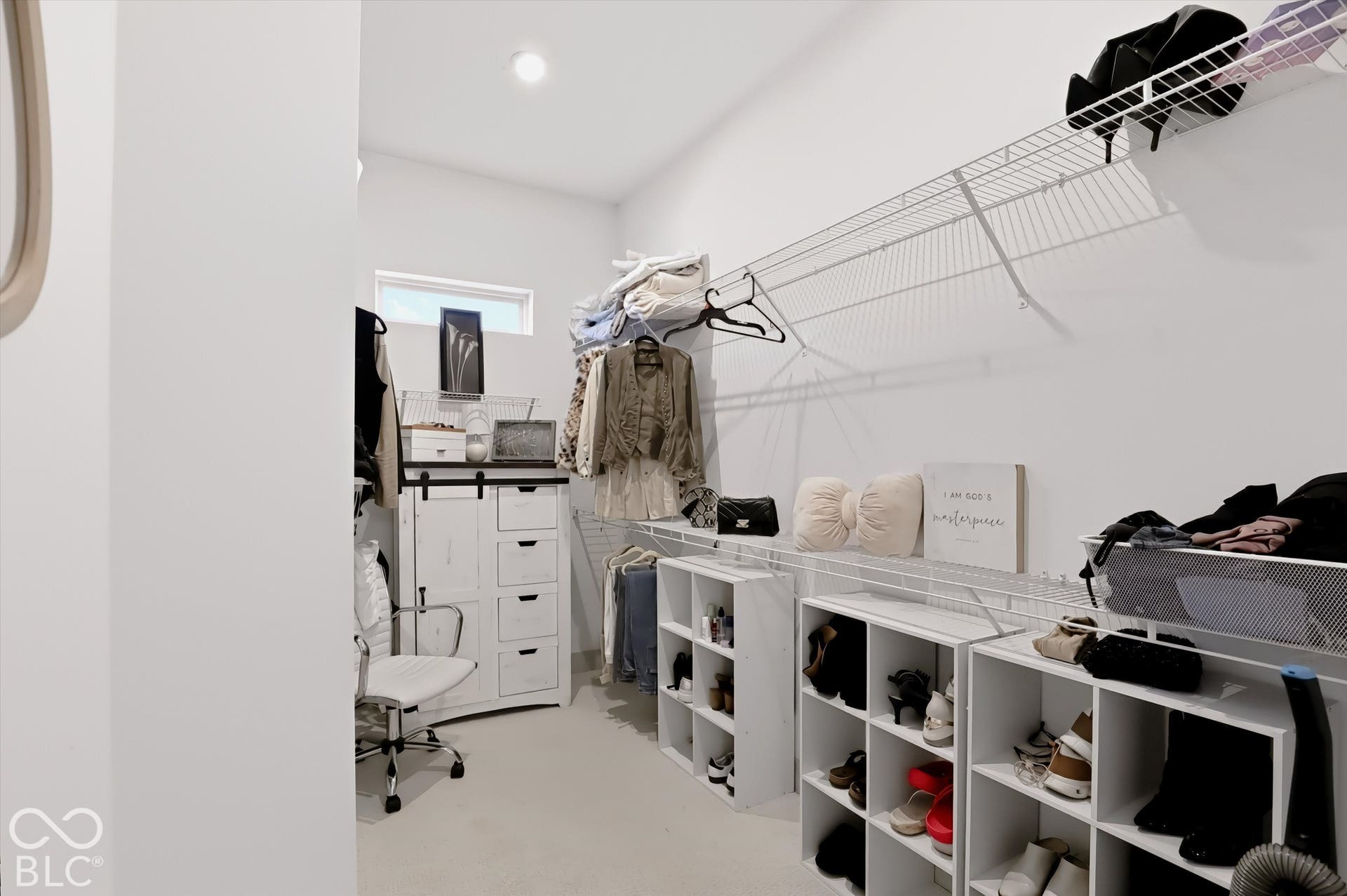 Walk-in closet featuring wire shelving, a transom window, and recessed ceiling lighting