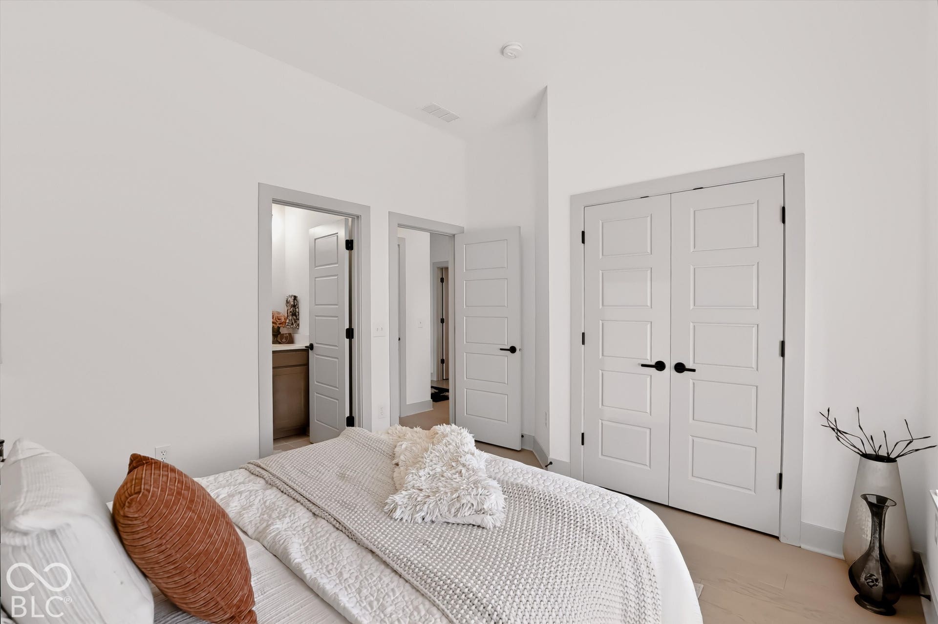 Interior room featuring wood-finish flooring, five-panel doors, and matte black hardware throughout