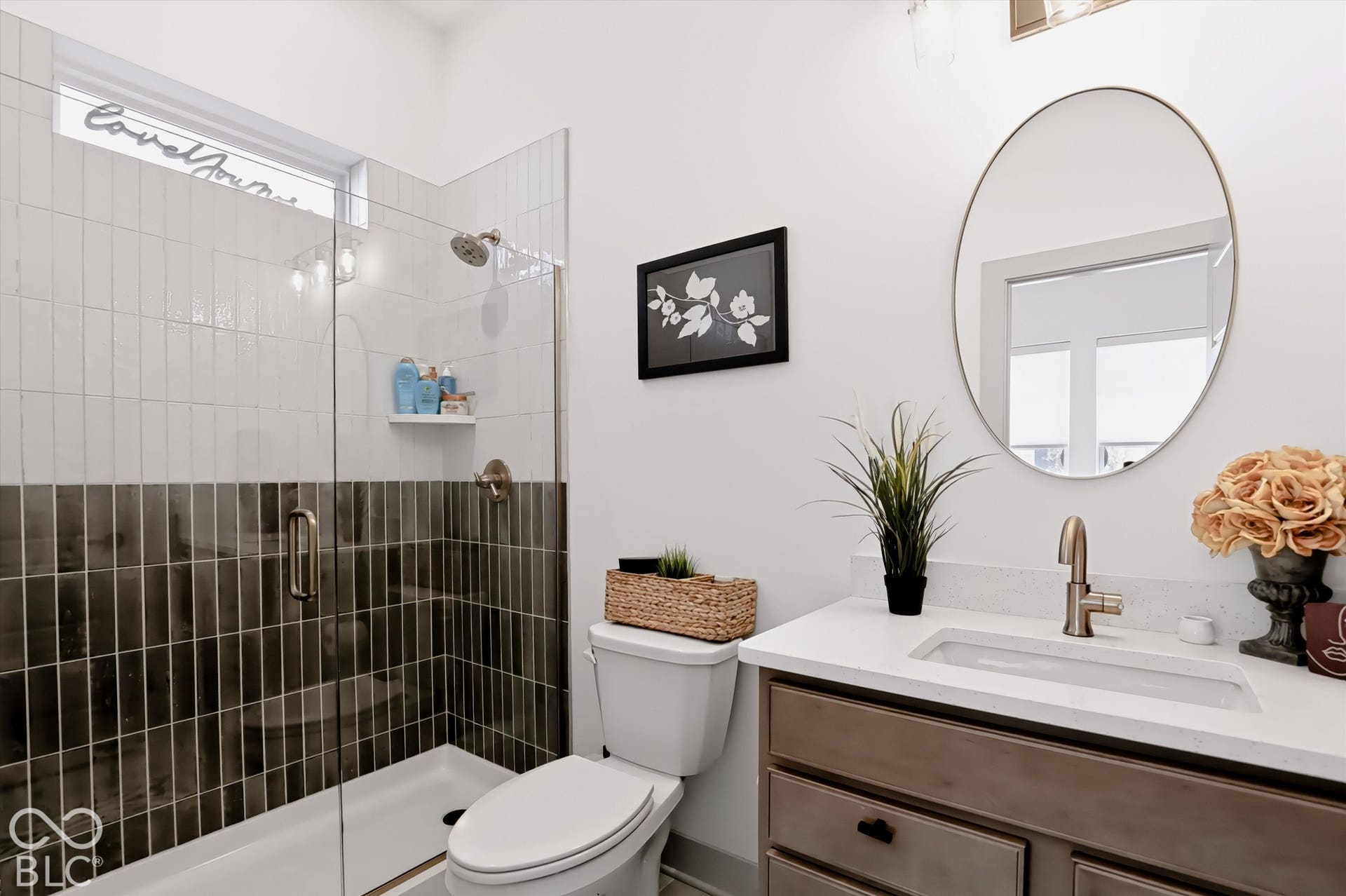 Bathroom featuring a vanity with a light-toned countertop, integrated rectangular sink, and metallic faucet