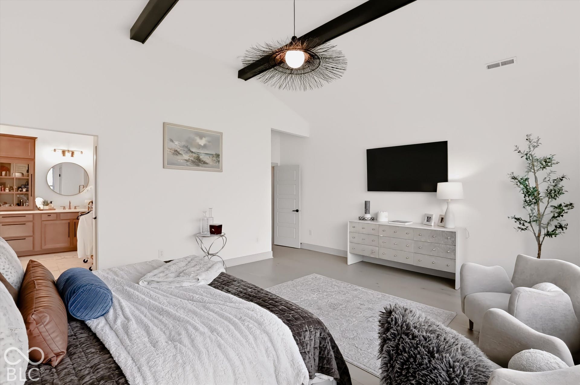 Vaulted ceilings featuring exposed structural beams and a decorative pendant light fixture