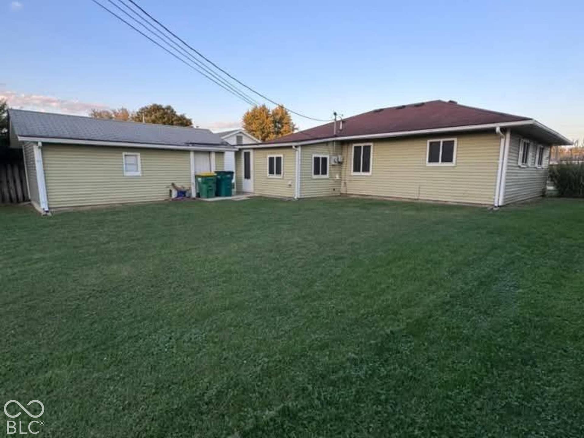 906 S Patterson, Lebanon, IN 46052 Expansive backyard featuring a level lawn and a detached garage with a metal roof