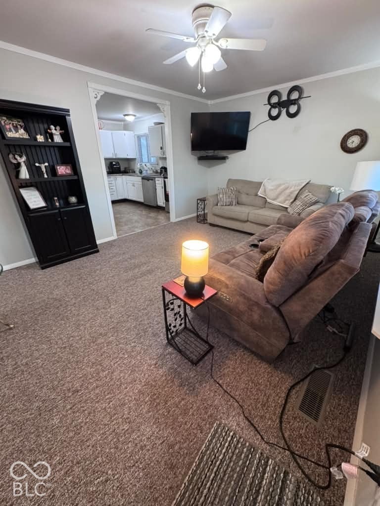 906 S Patterson, Lebanon, IN 46052 Neutral carpeting, ceiling fan with integrated lighting, and arched doorway entry featuring decorative trim work