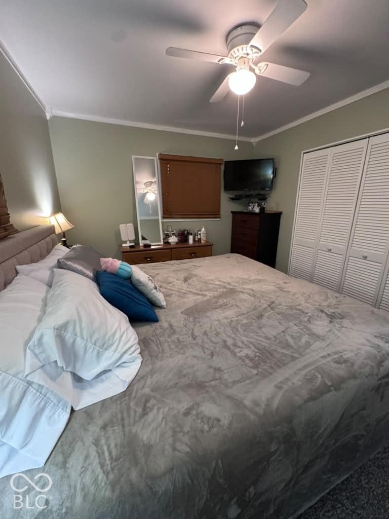 906 S Patterson, Lebanon, IN 46052 Bedroom featuring a ceiling fan with integrated lighting, louvered-style closet doors, and a window with a retractable blind