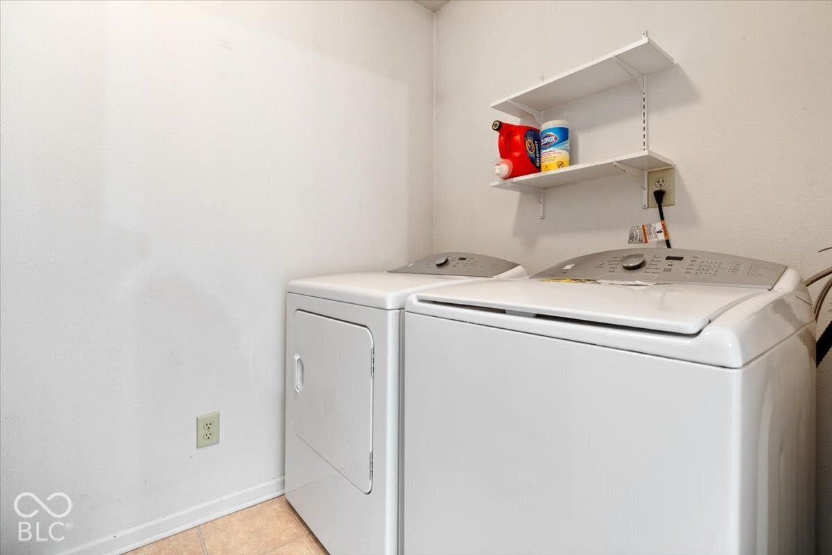 Wall-mounted white shelving and neutral flooring