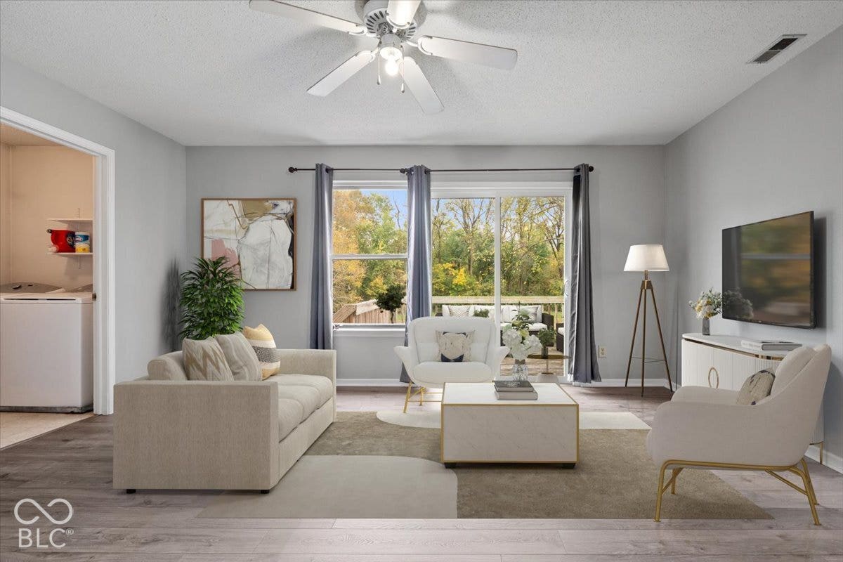 Virtually Altered - Living area featuring wood-finish flooring, sliding glass door, ceiling fan, and access to a deck