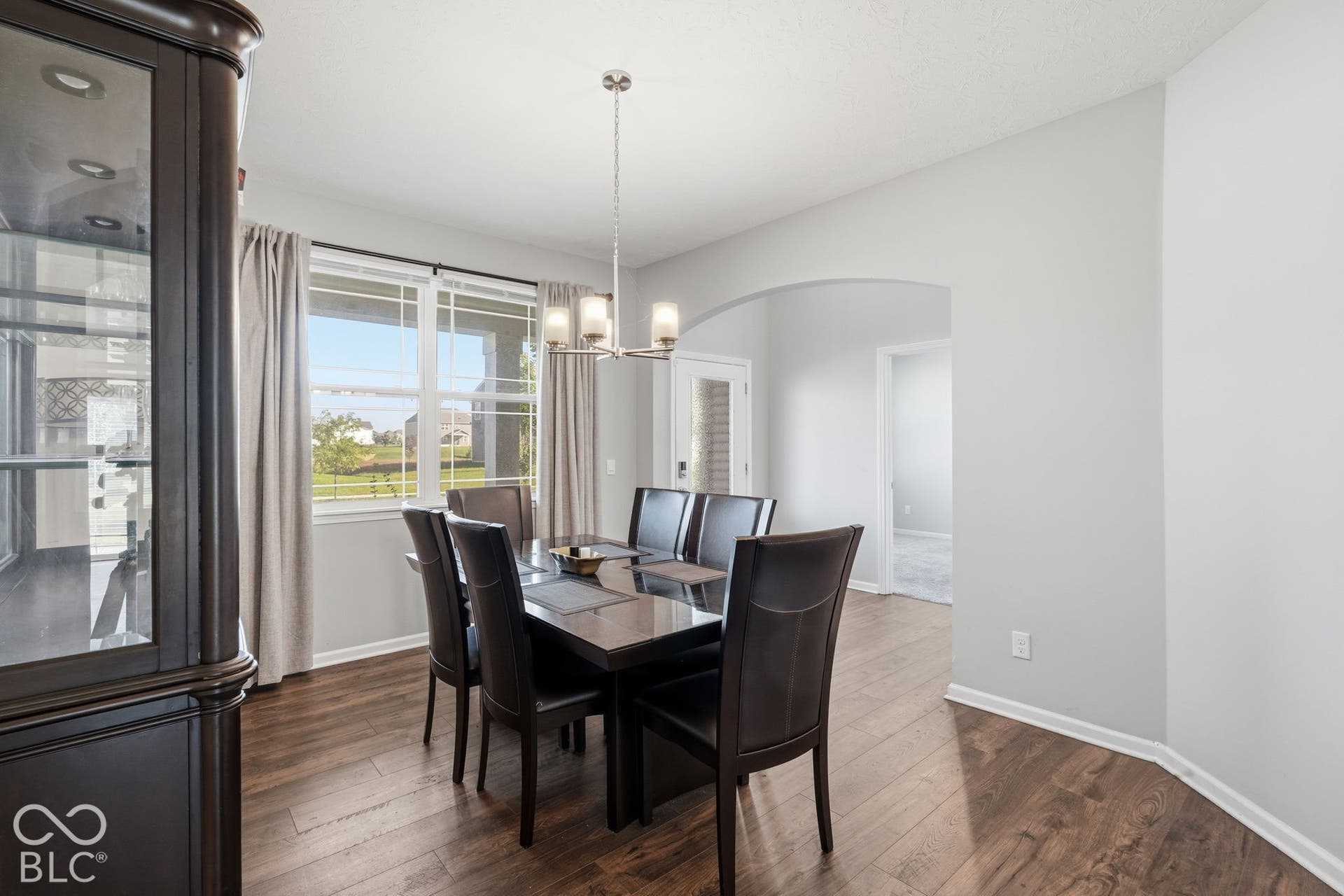 Separate space with arches for dining.