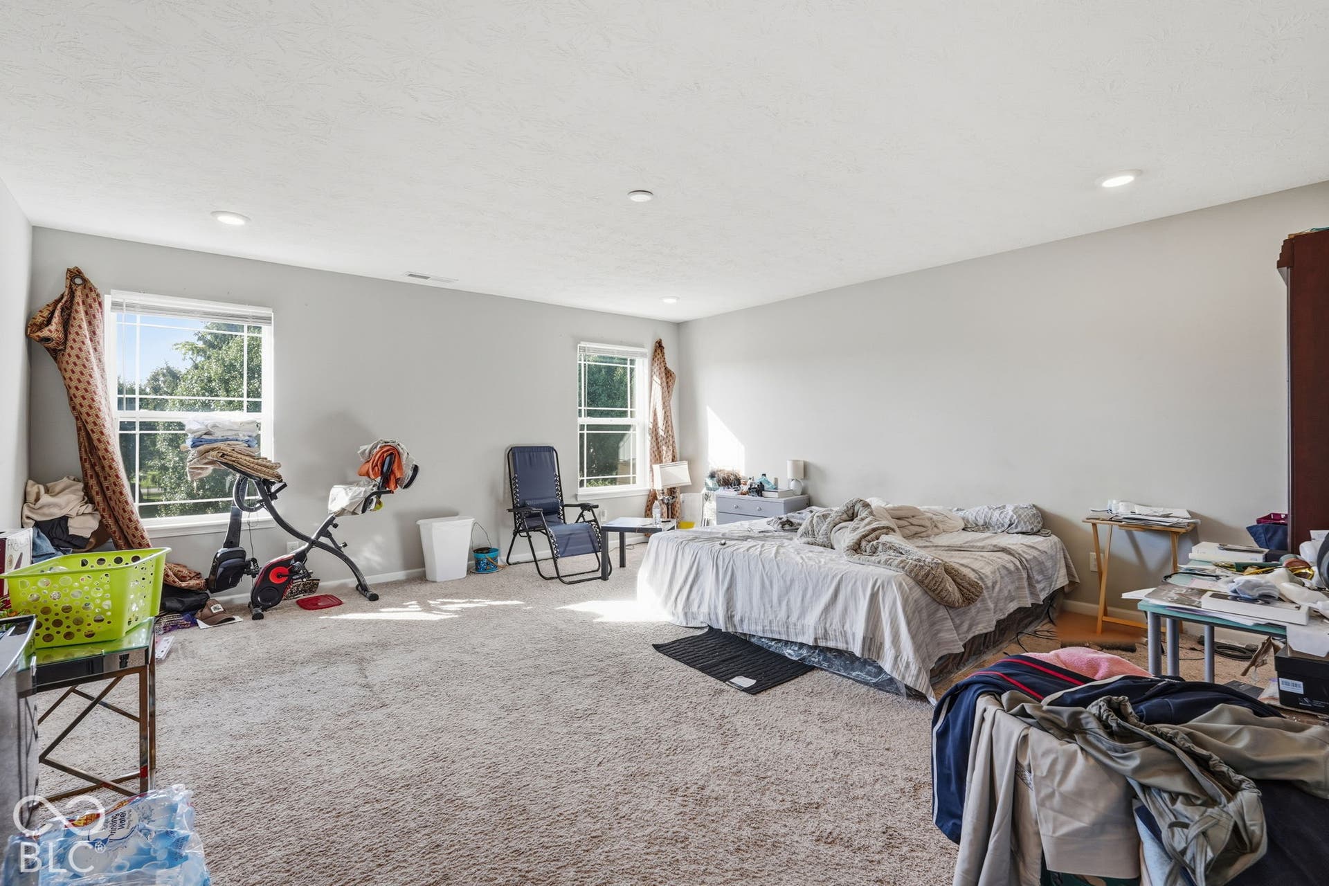 Primary bedroom with a primary bathroom attached and two walk-in closets,