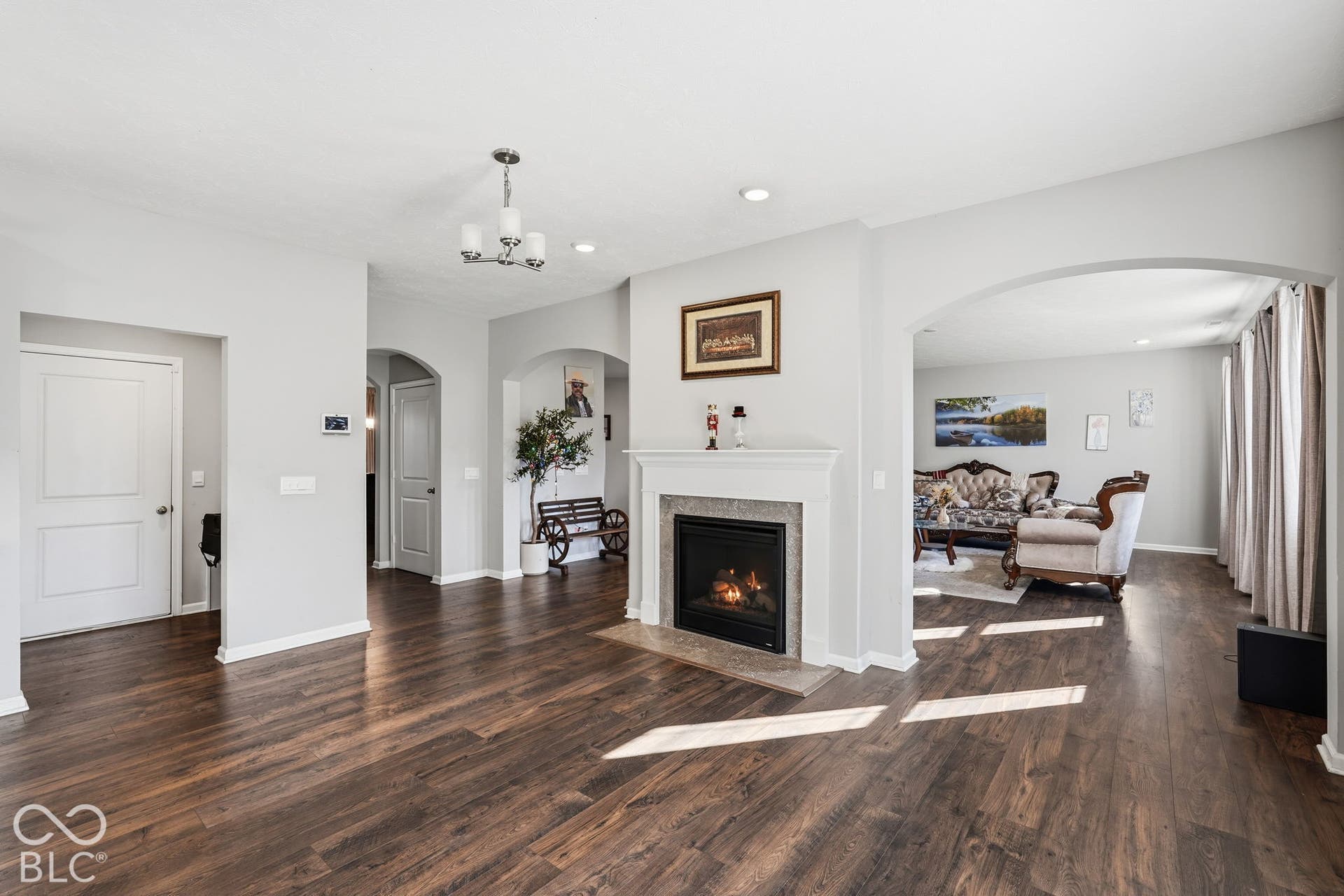 Double-sided gas fireplace visible in kitchen.
