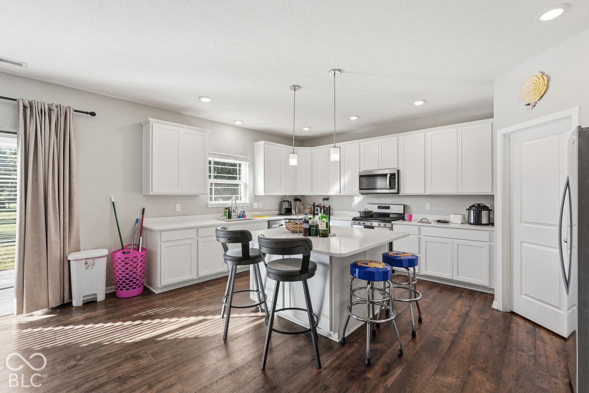 Kitchen with a center island and space to sit and eat in the kitchen.