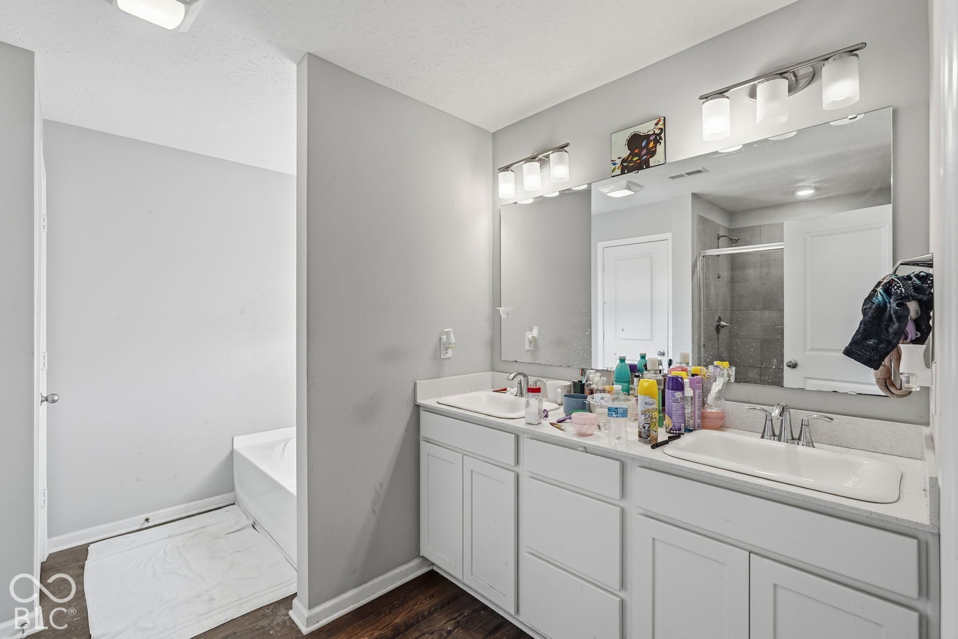 Primary bathroom with separate shower stall and bathtub.