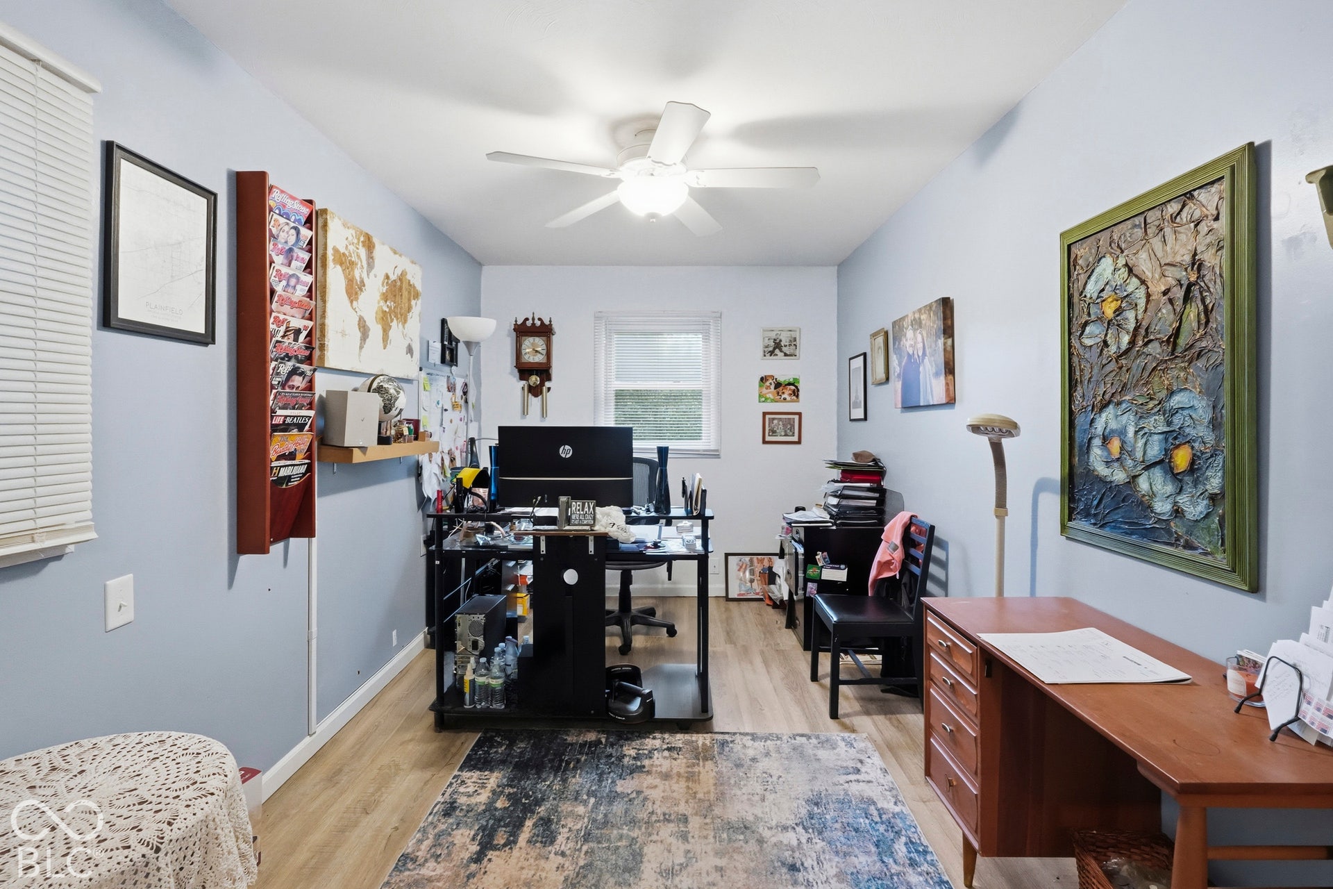 The dining room is being used as an office. It has a nice ceiling fan with integrated lighting, and horizontal window blinds. Vinyl plank flooring.