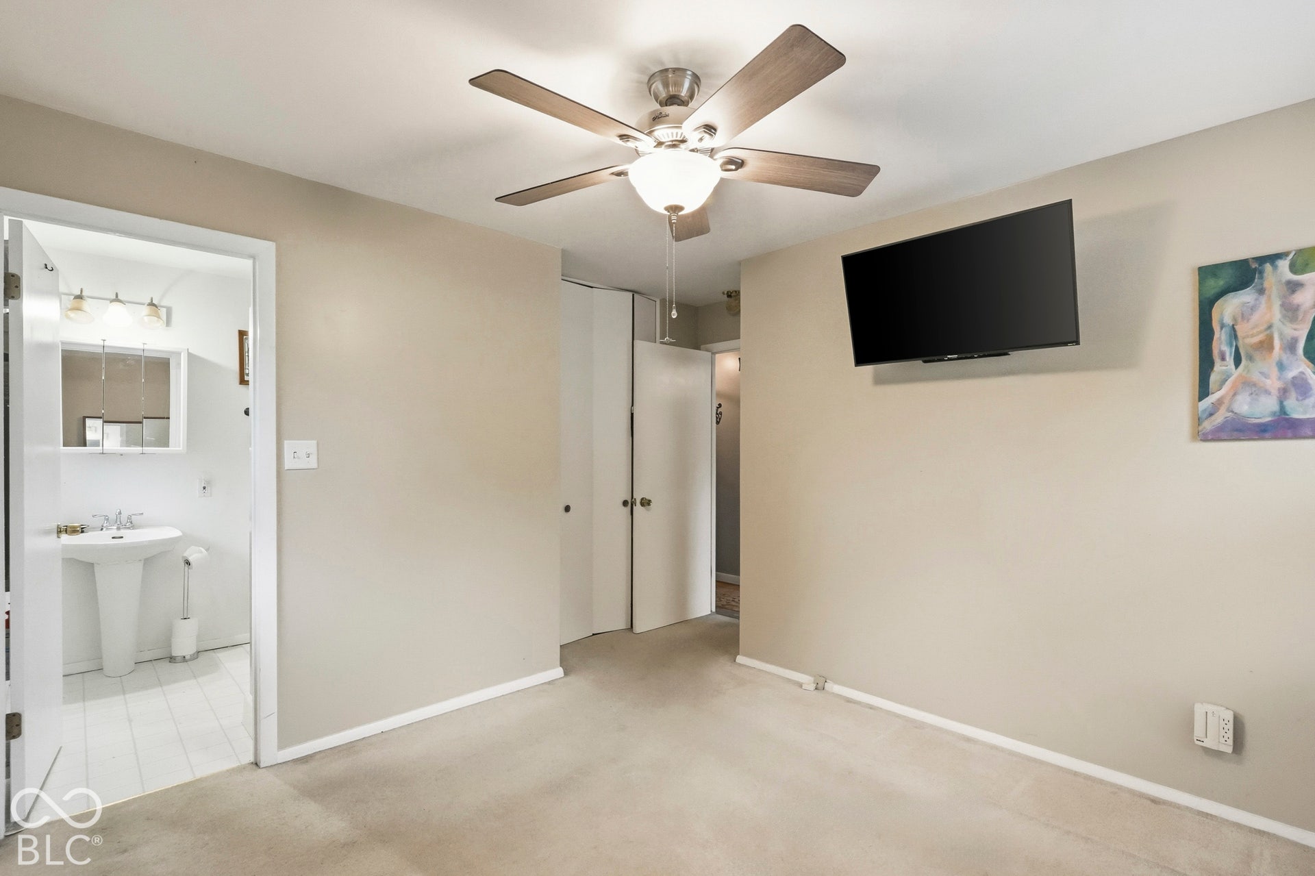 Another view of the primary suite. From this angle you see the entrance to the en-suite bathroom.