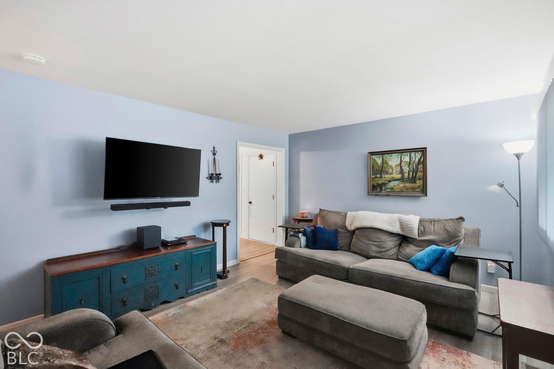Living area featuring smooth-finish ceilings and vinyl plank flooring.