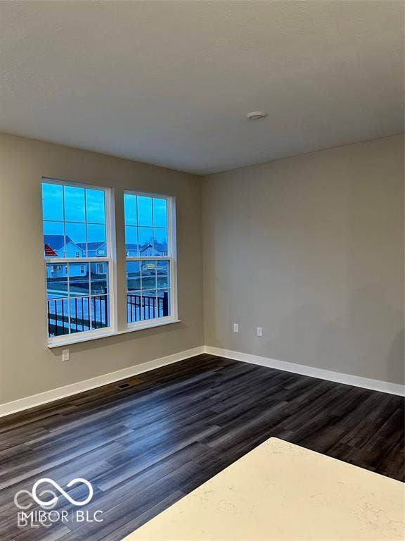 Neutral wall finishes, wood-finish flooring, and double-pane windows with integrated muntins