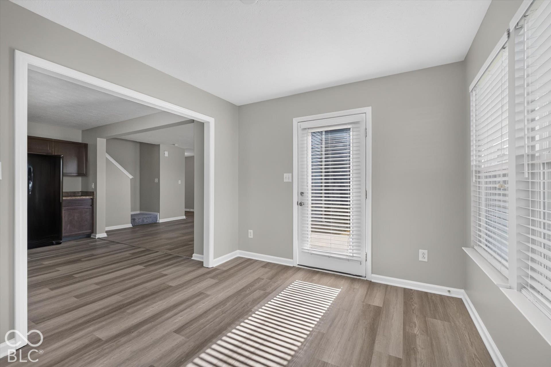Versatile sun room with newer LVP flooring and abundant natural light