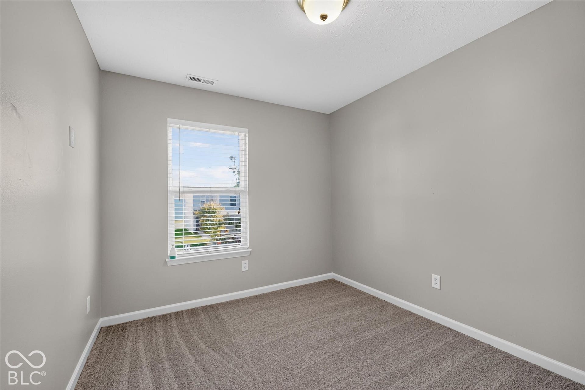 3rd bedroom with new carpet and neutral wall color