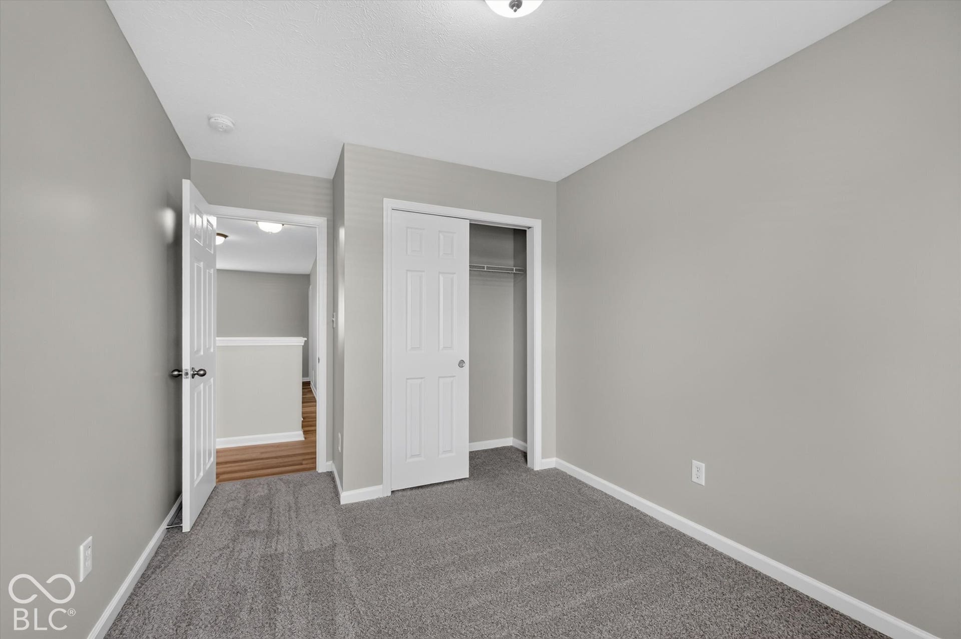 2nd bedroom with new carpet and neutral wall color