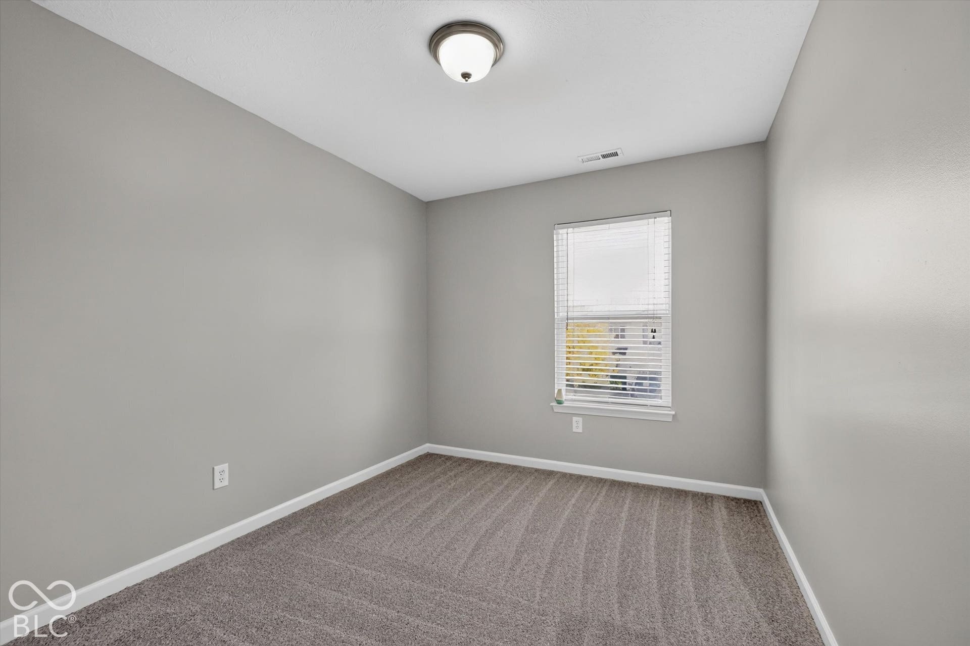 2nd bedroom with new carpet and neutral wall color