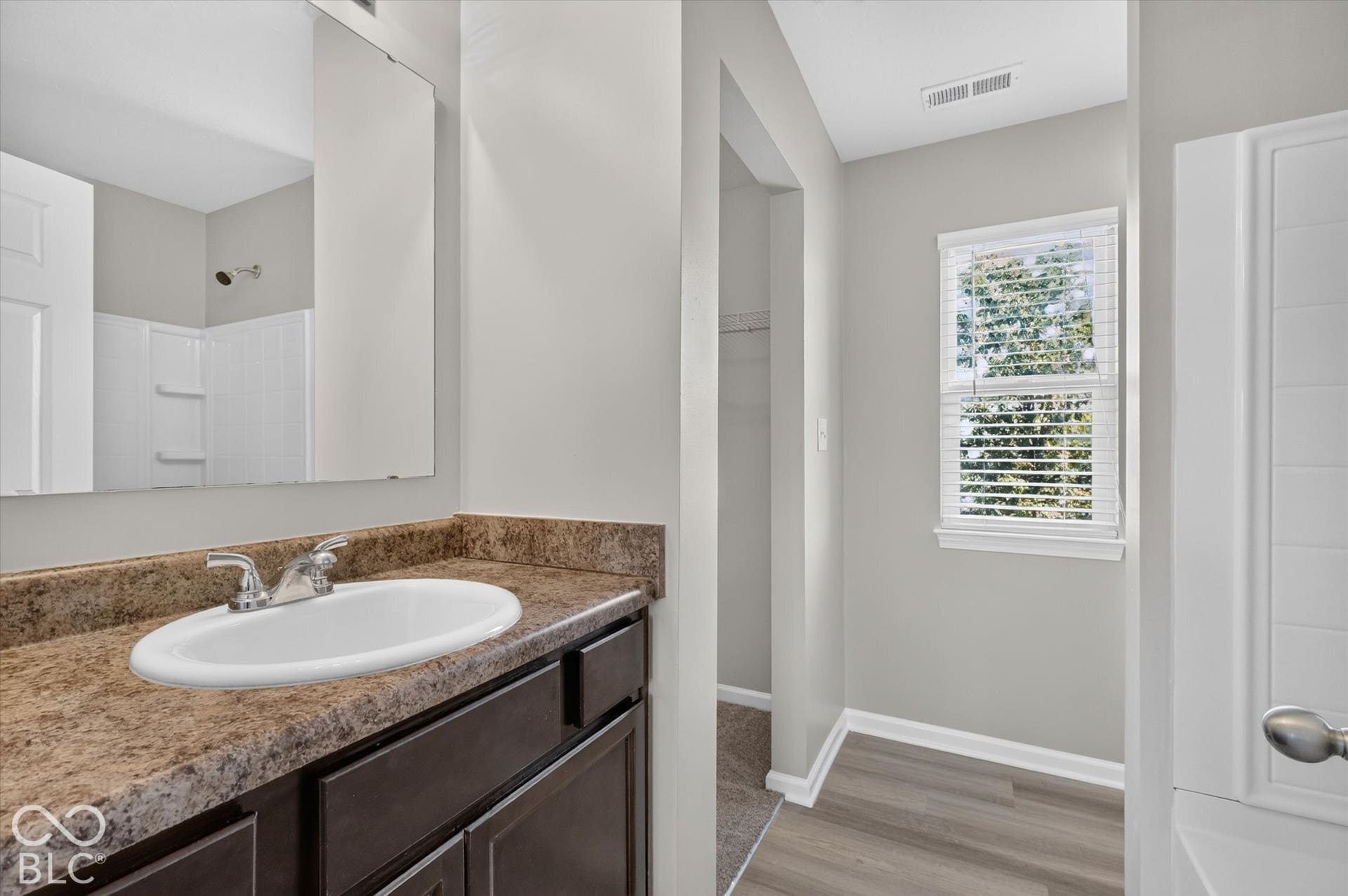 Primary bathroom featuring a vanity and shower/bathtub combination
