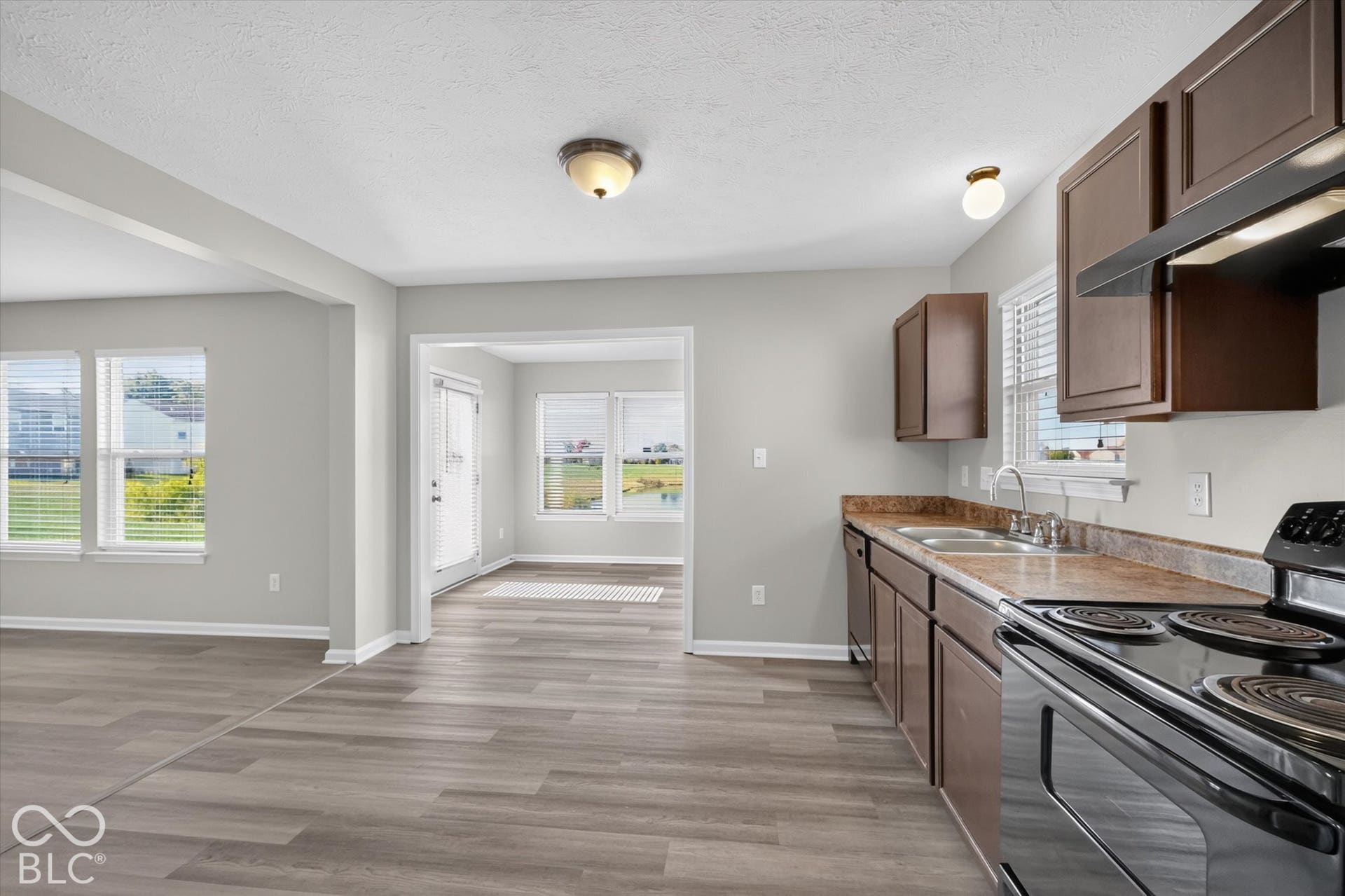 Kitchen featuring newer LVP flooring and black appliances