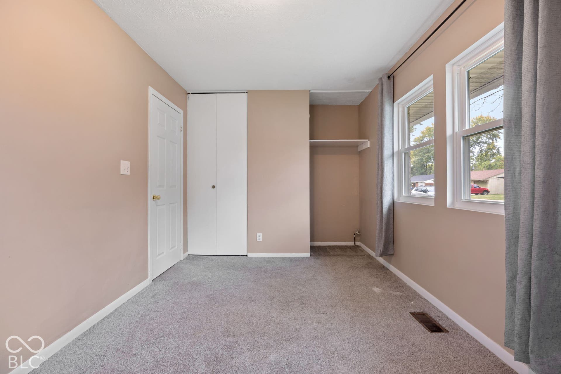 3721 Ireland Drive, Indianapolis, IN 46235 Interior room featuring neutral wall paint, wall-to-wall carpeting, dual-pane windows, and a built-in closet with double-panel doors