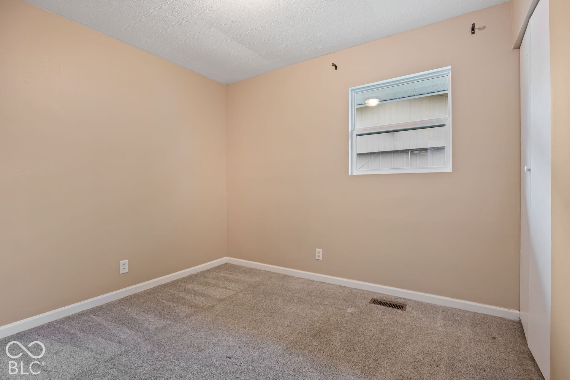 3721 Ireland Drive, Indianapolis, IN 46235 Neutral wall tones, carpeted flooring, and a single-hung window with white trim