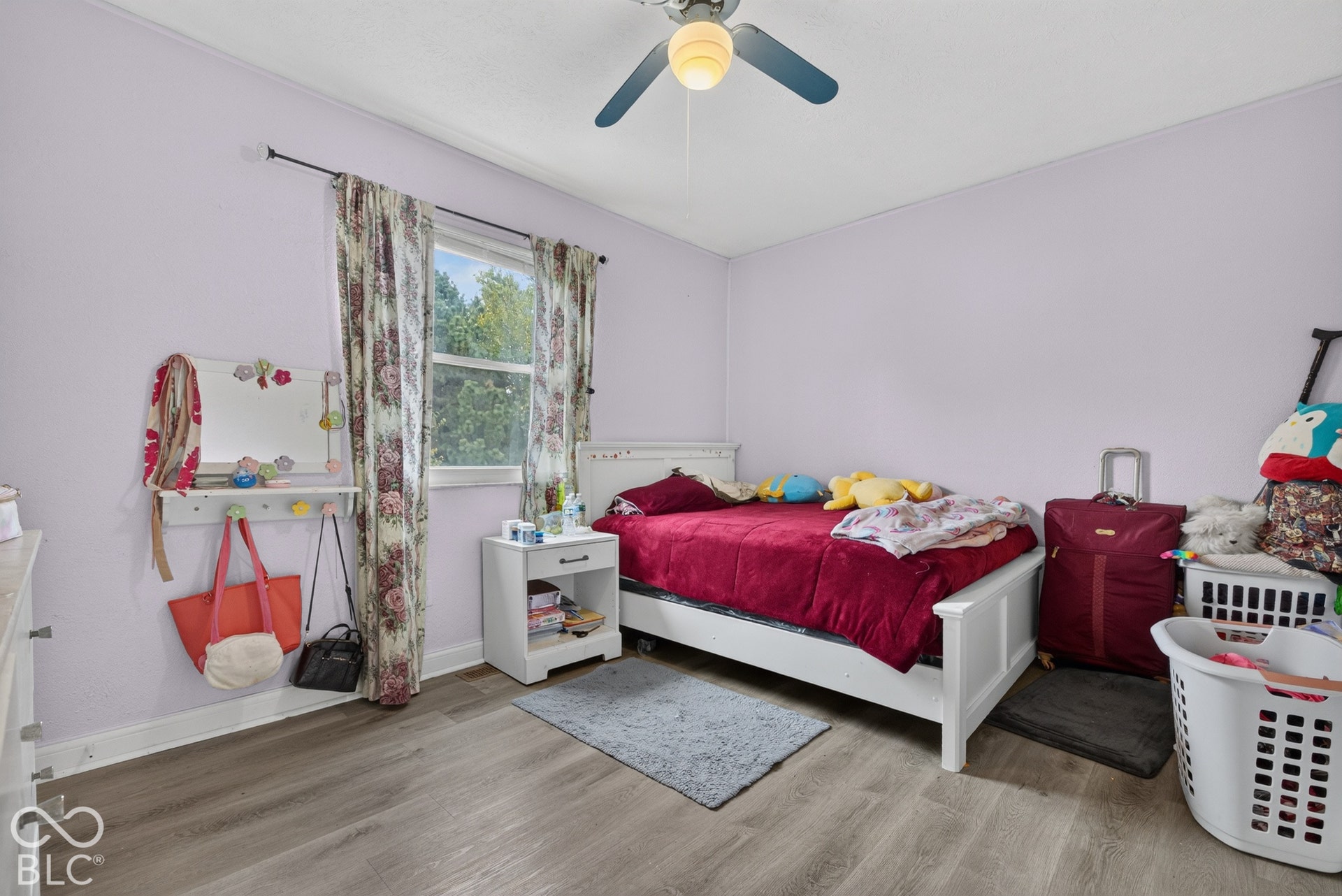 Wood-finish flooring, single-pane window, and ceiling fan with integrated lighting