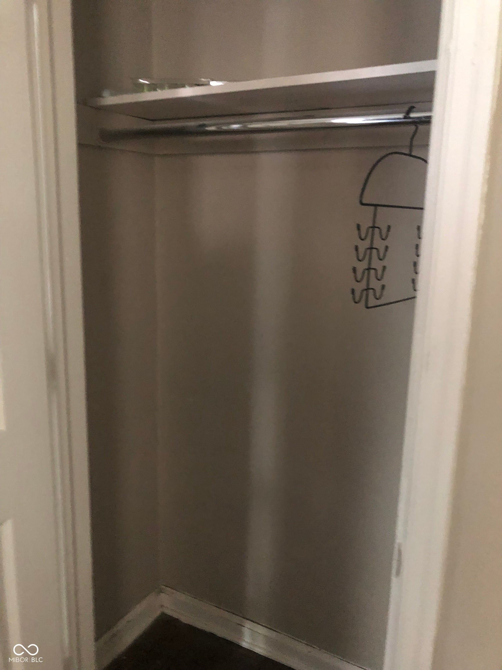 Recessed closet with a single shelf and clothing rod