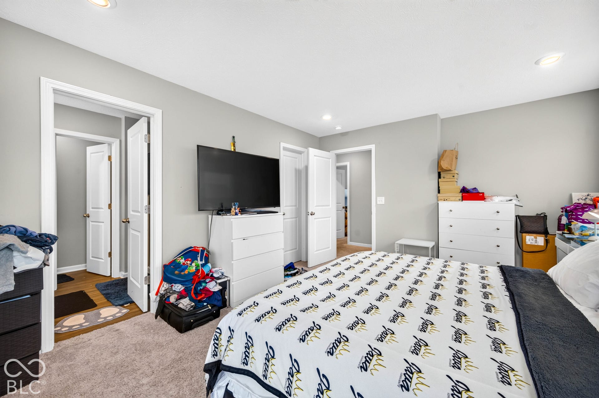 Neutral-toned walls, recessed lighting, and wall-to-wall carpeting