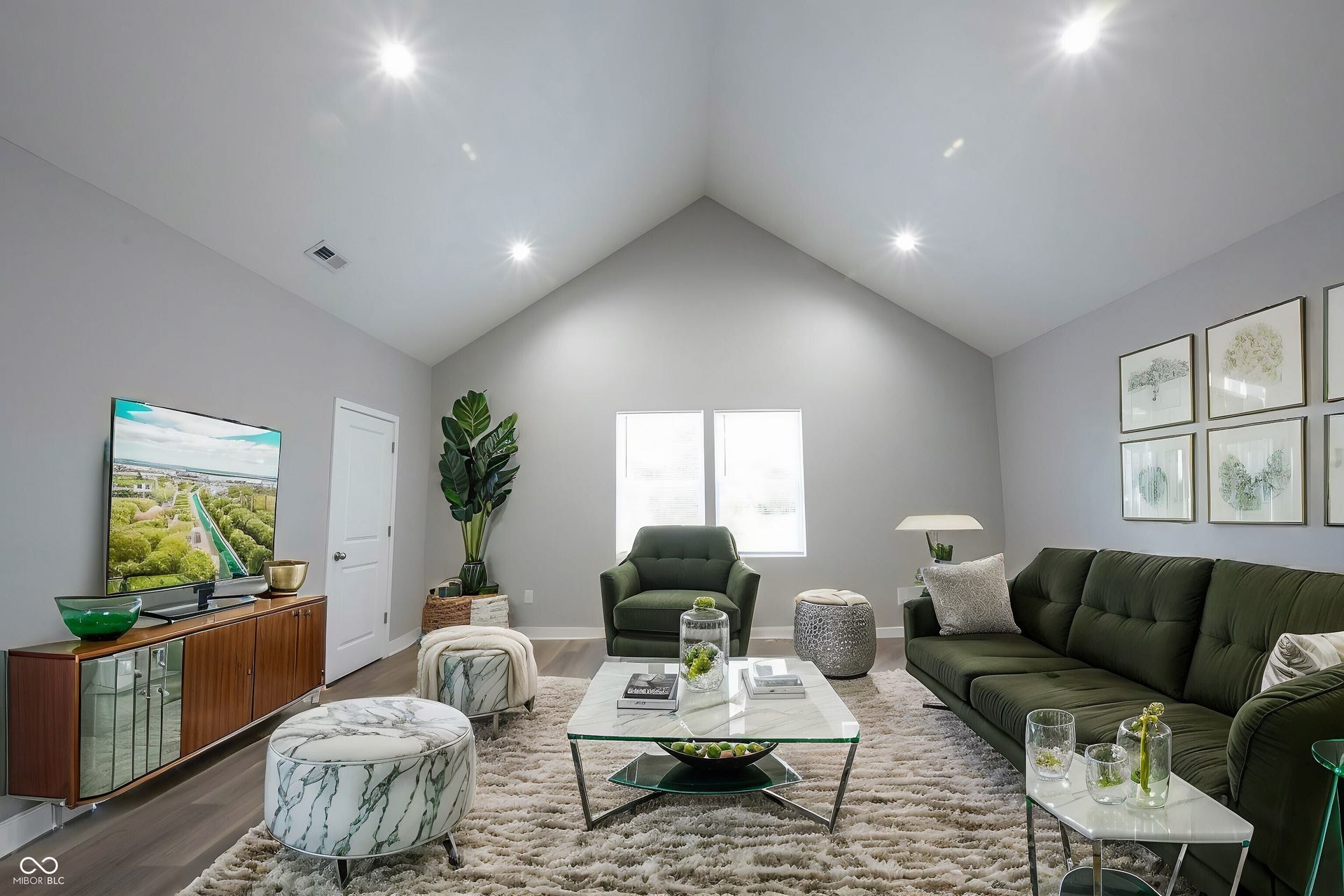 Living room featuring a vaulted ceiling with recessed lighting