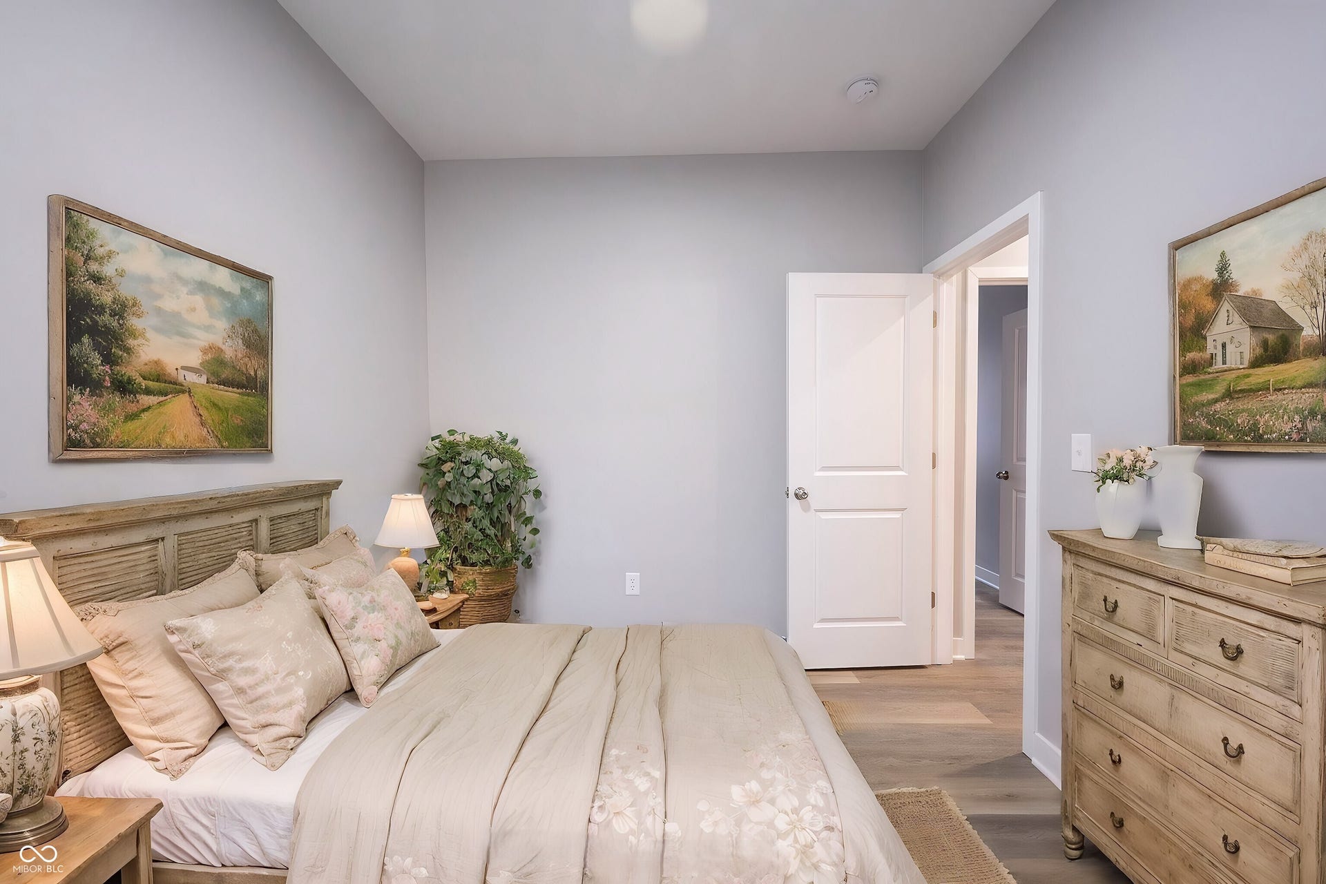 Light gray walls complement the wood-finish flooring in this room