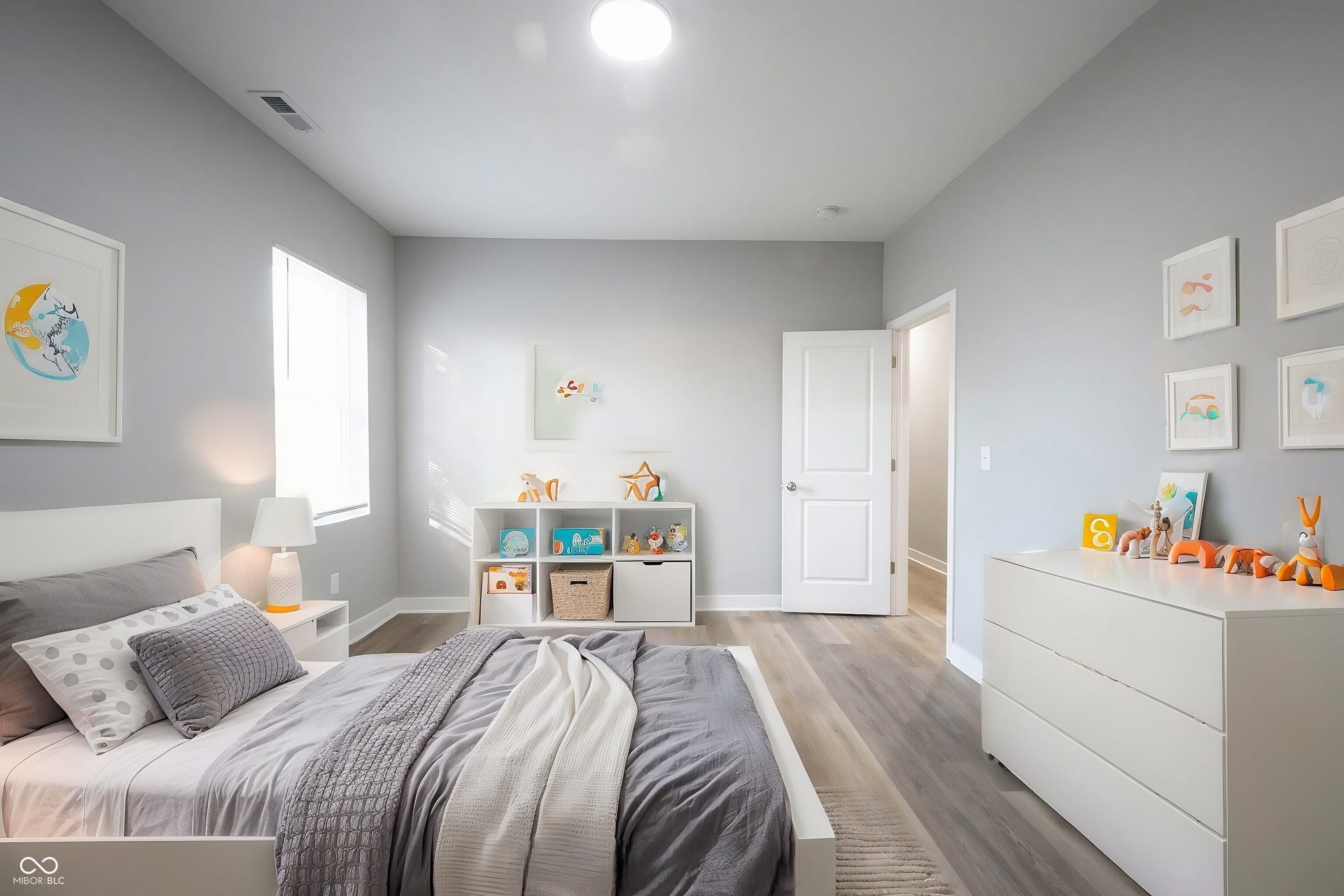 Light gray walls complement the wood-finish flooring in this room