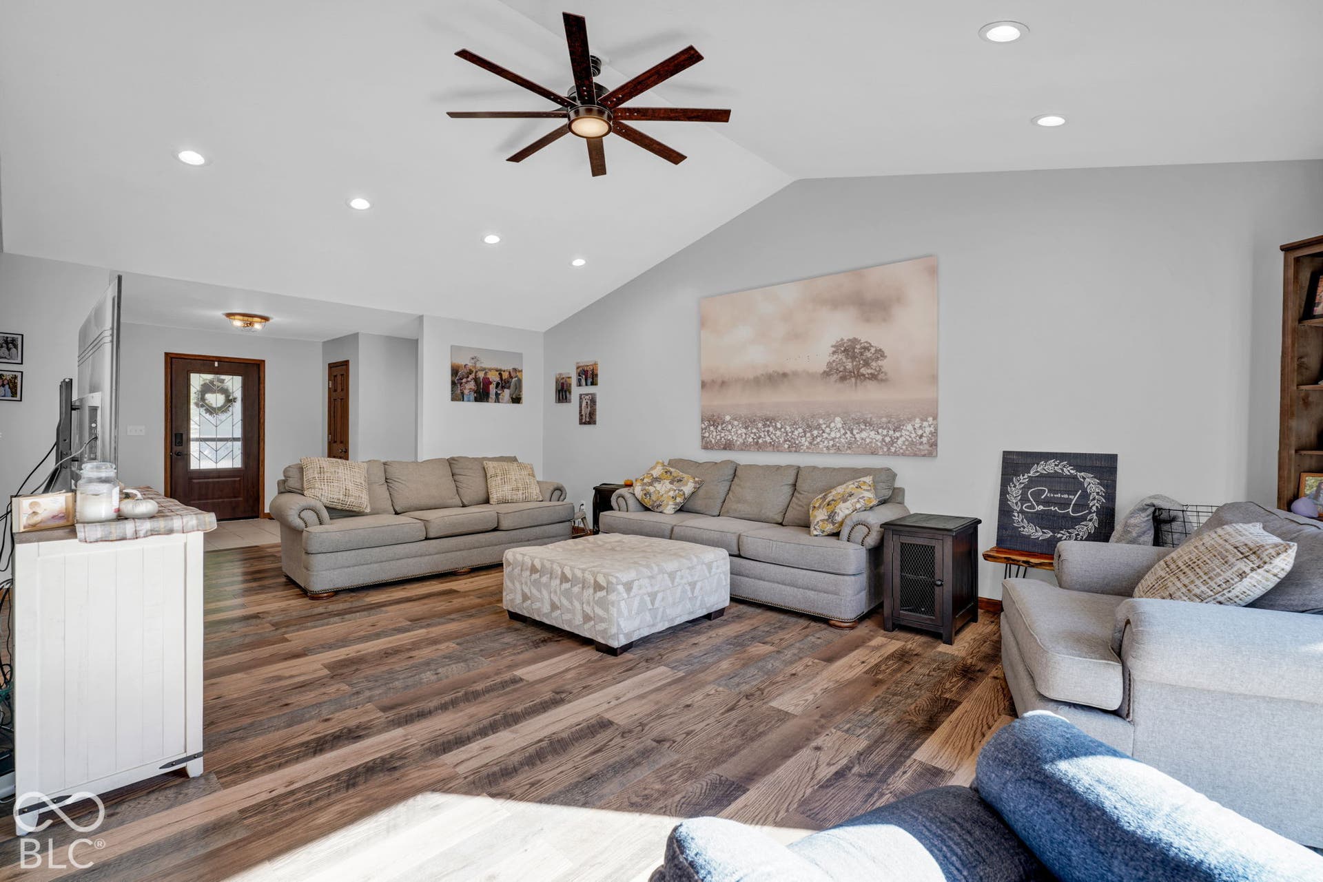 Vaulted ceilings, wood-finish flooring, multi-blade ceiling fan, and recessed lighting