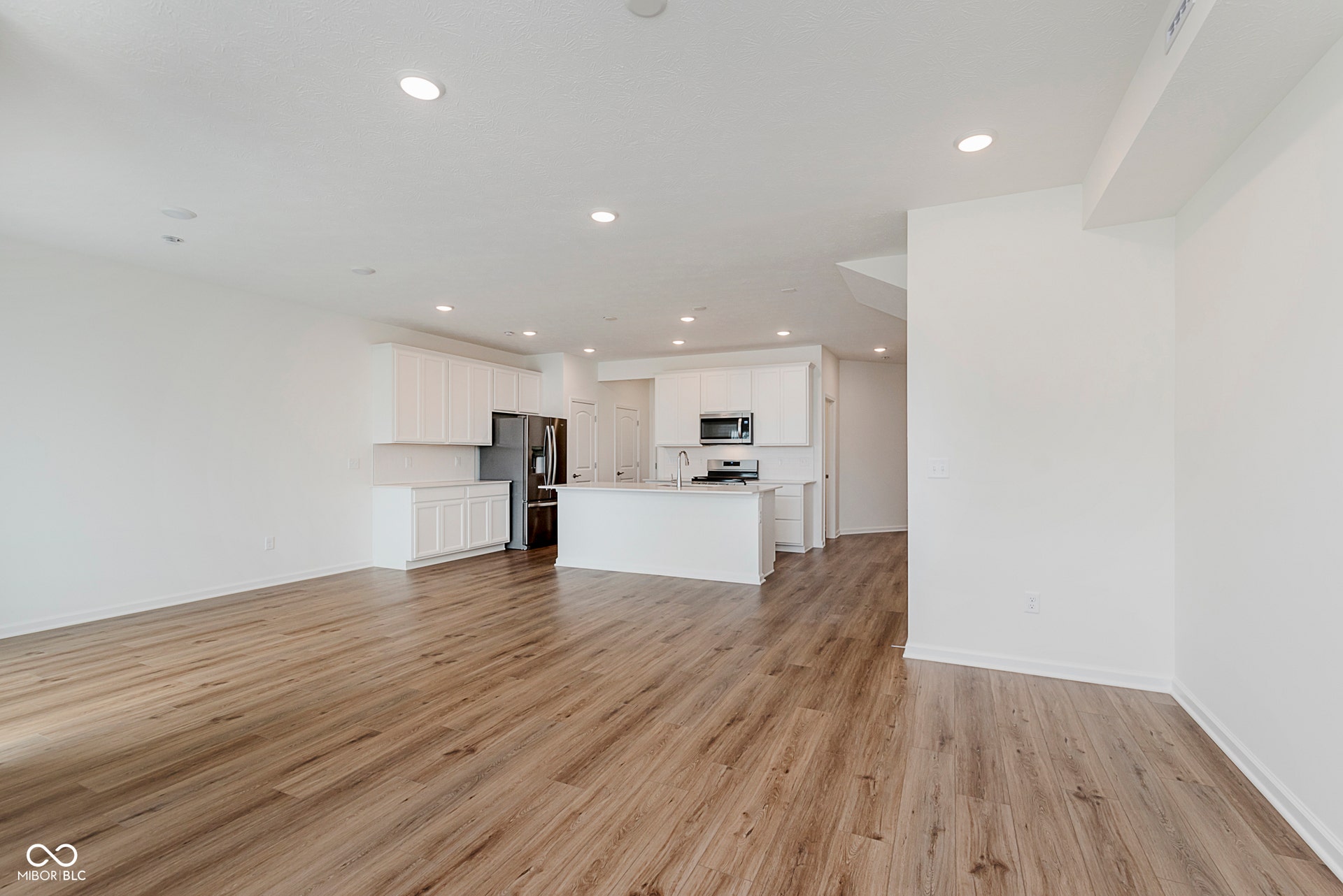 unfurnished living room with light wood-style floors and recessed lighting