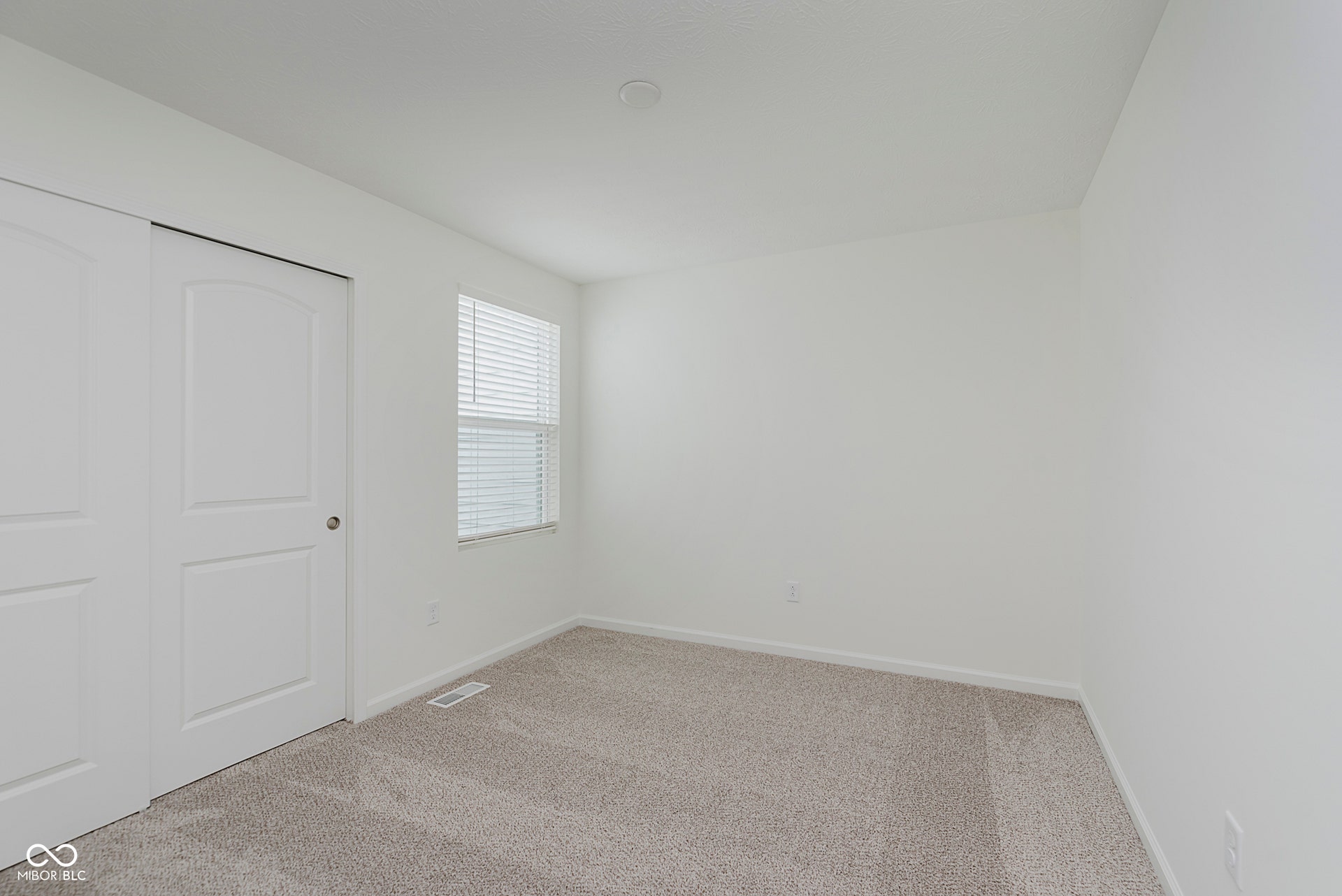 unfurnished bedroom with carpet floors and a closet