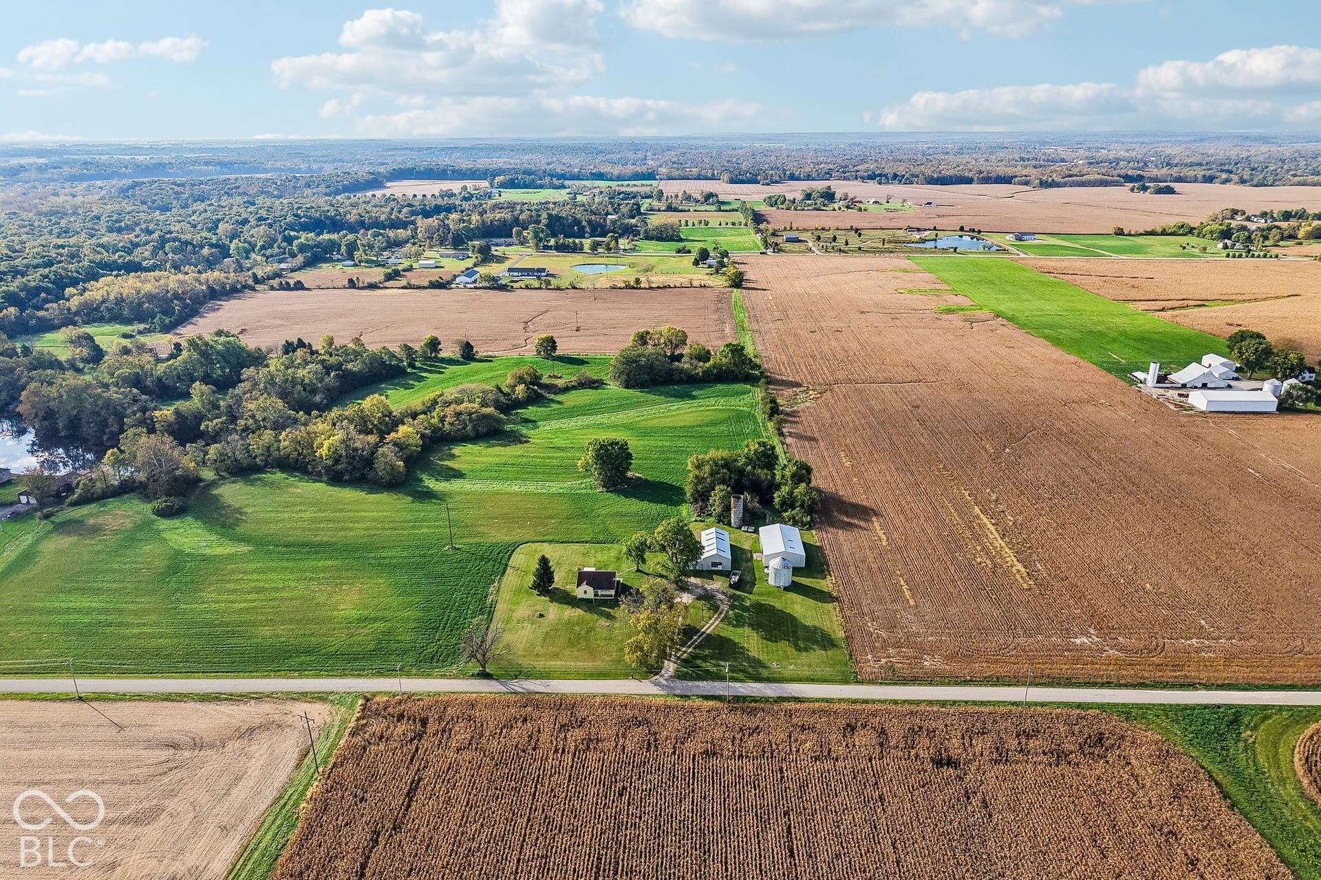 4469 E 400 S, Franklin, IN 46131 Aerial perspective of expansive acreage featuring a residence, multiple outbuildings, grain silos, and established pasture land