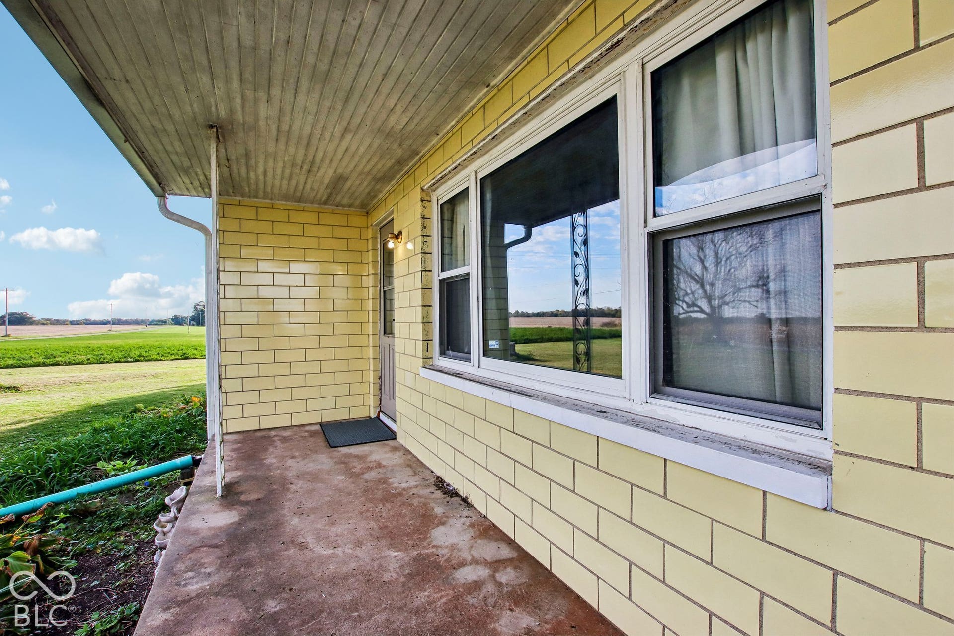 4469 E 400 S, Franklin, IN 46131 Exterior porch featuring glazed masonry wall cladding, a concrete floor, and large pane windows