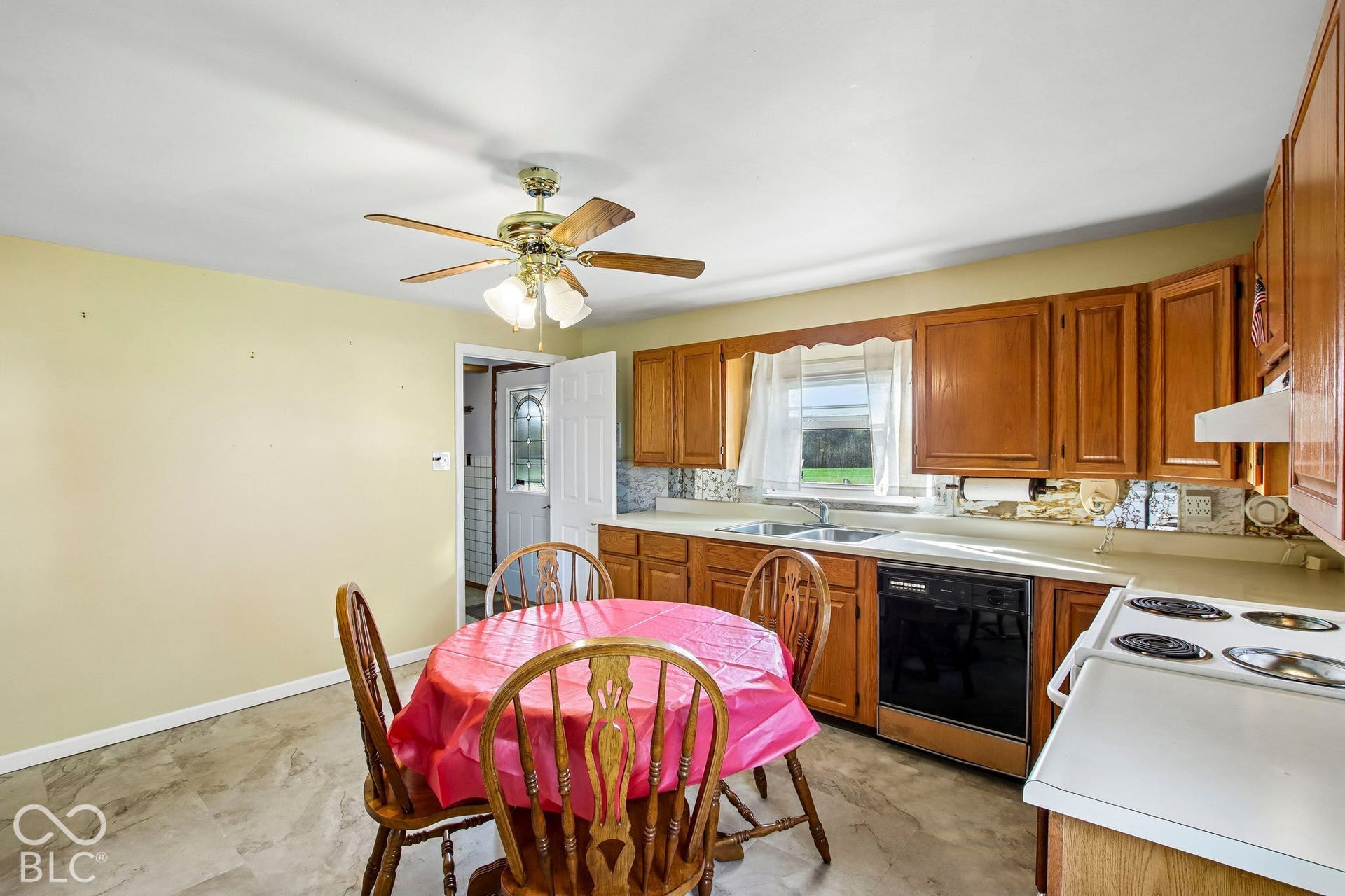 4469 E 400 S, Franklin, IN 46131 Kitchen featuring natural wood cabinetry, a dual-basin sink, a built-in dishwasher, an electric range, and stone-finish flooring