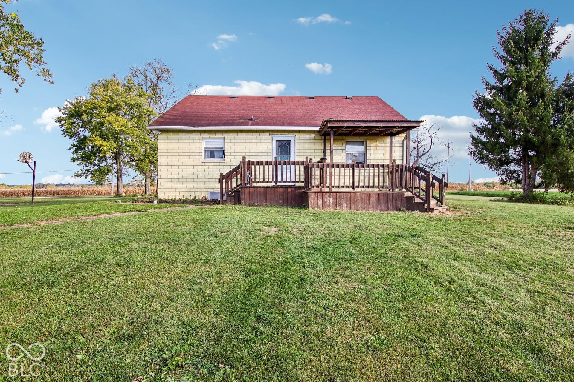 4469 E 400 S, Franklin, IN 46131 Brick exterior residence featuring a raised wood deck with balustrades and an expansive yard